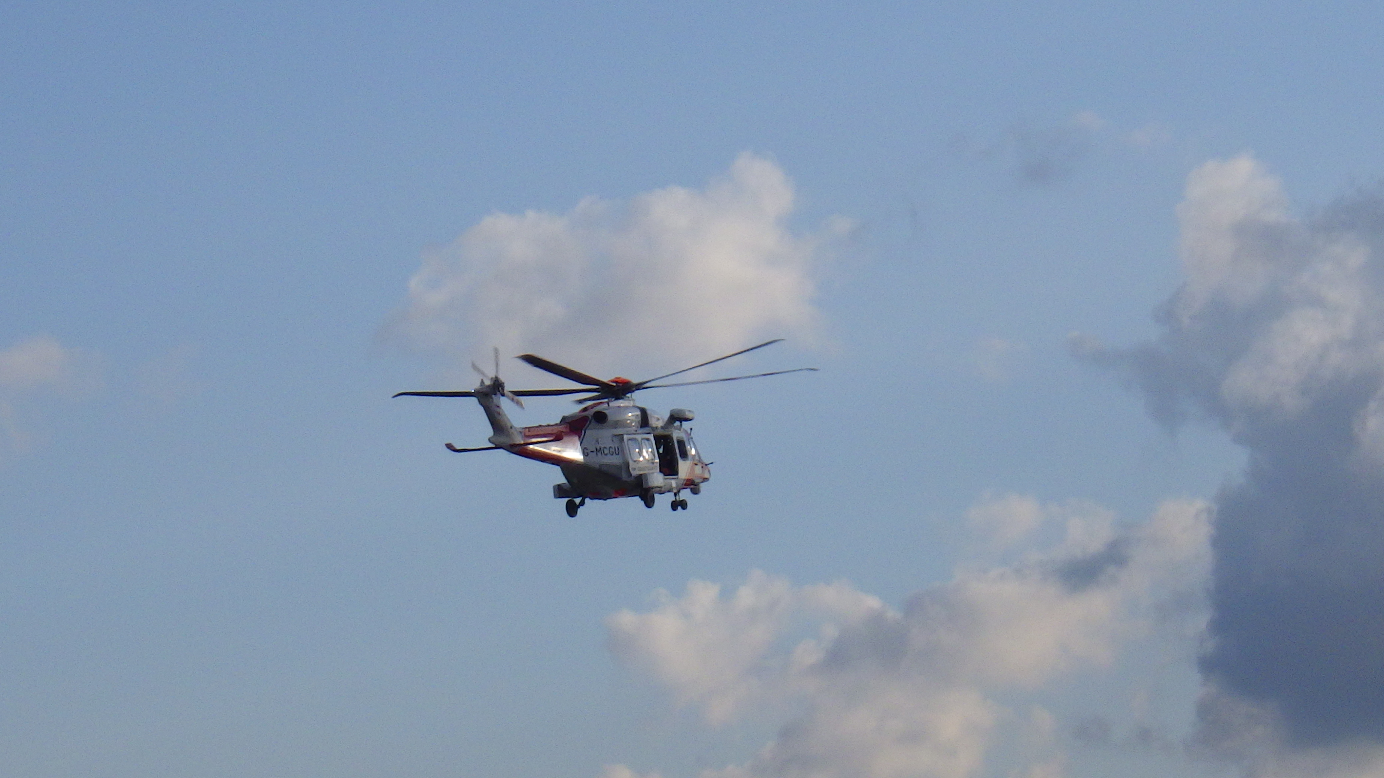 Rescue 163 helicopter above the water of the river Alde
