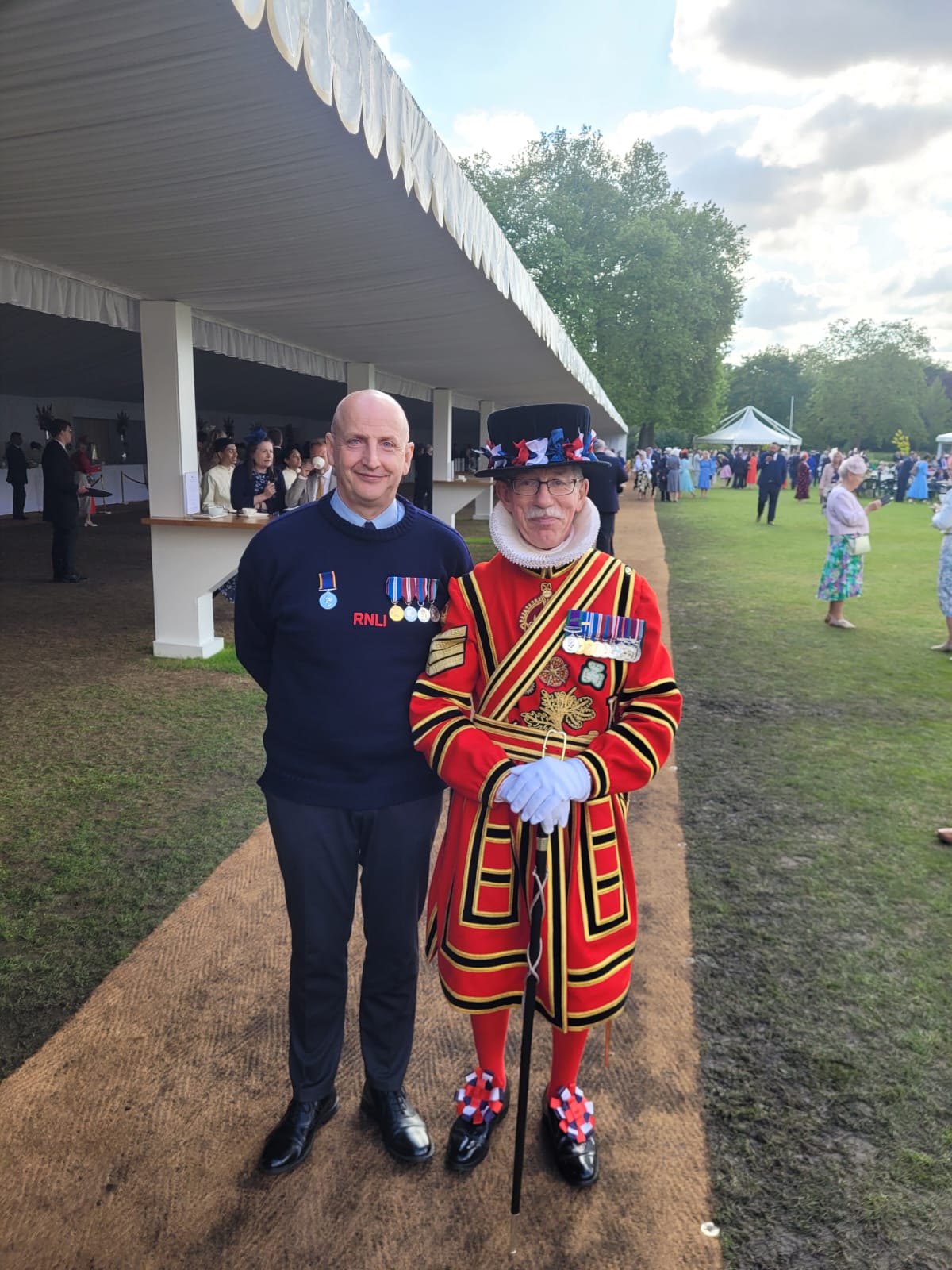 Andy Liston, crew member at New Brighton RNLI, poses alongside a fully decorated Palace Guard.