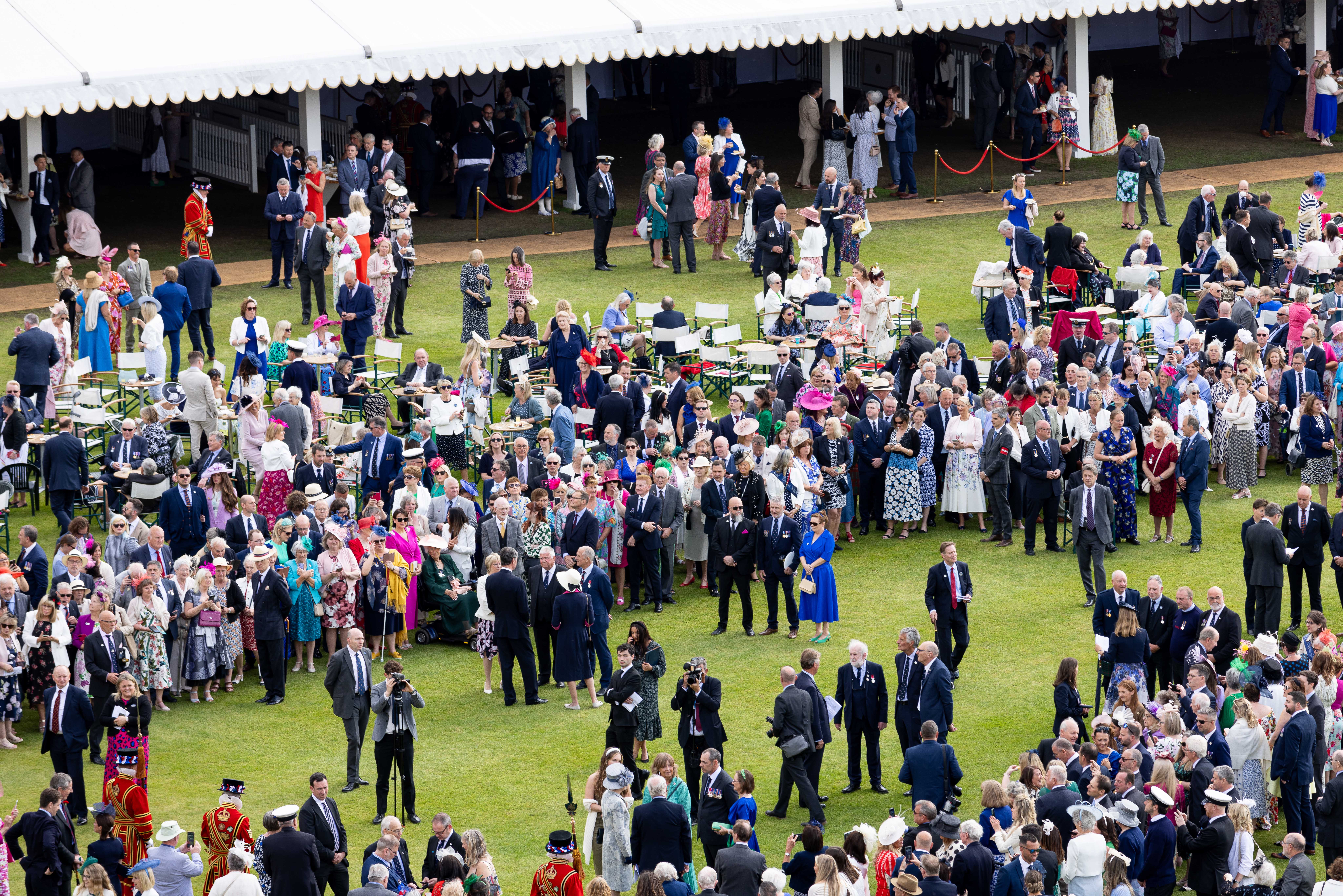 The lawn at Buckingham Palace with crowds of guests. 