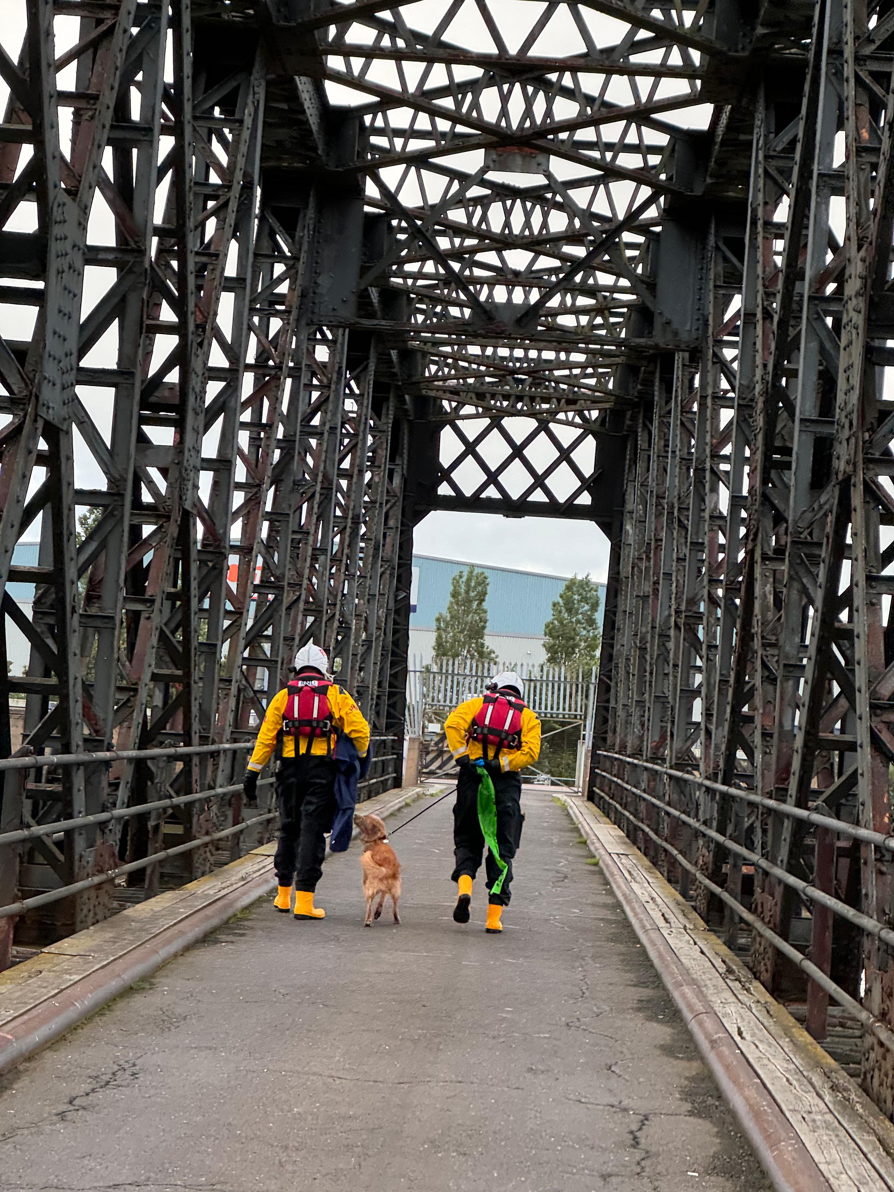 Two of Gravesend RNLI's volunteer crew take the rescued dog to be reunited with its owner