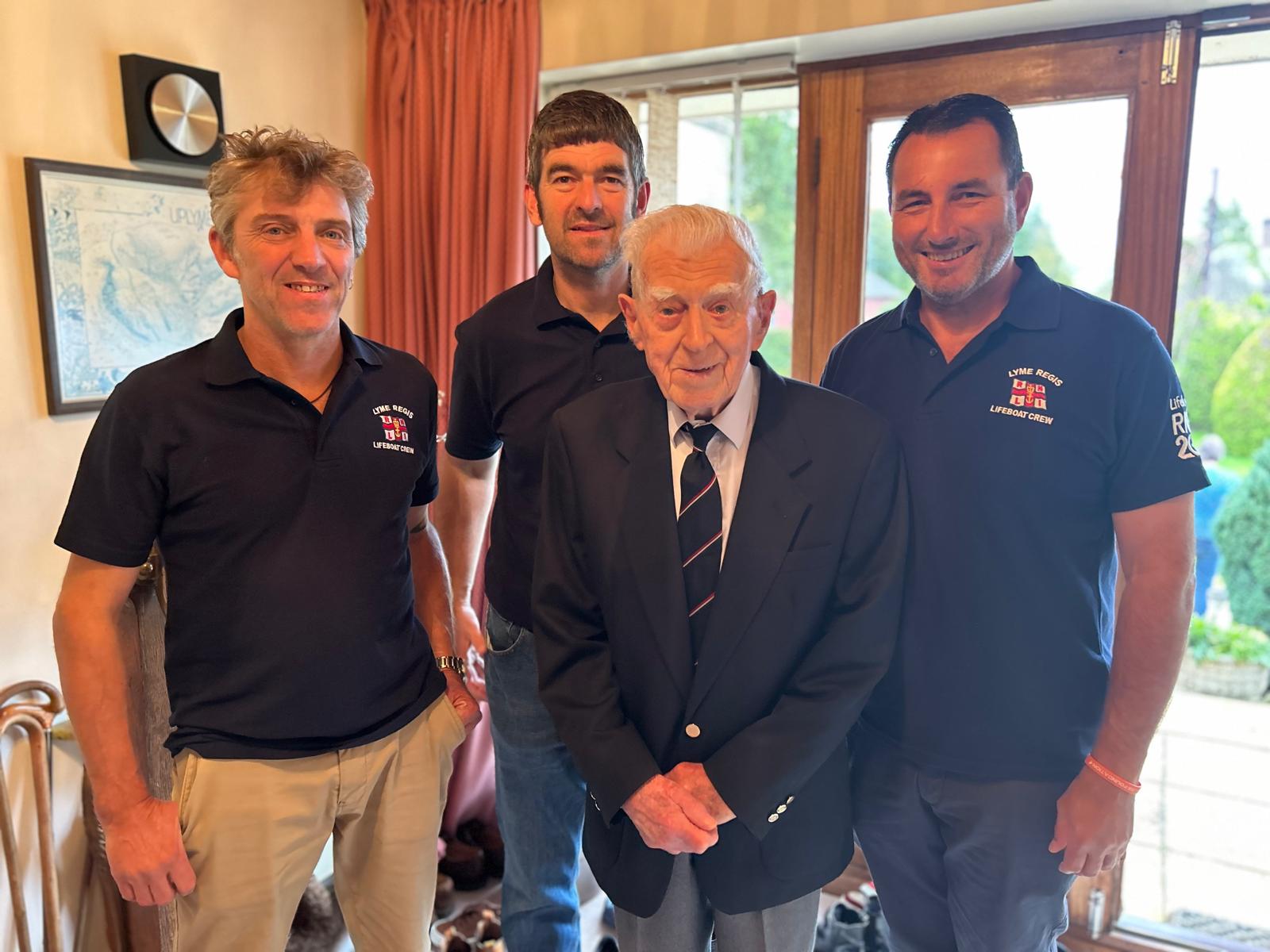 Photo of Mr Fred Day with three lifeboat volunteer crew