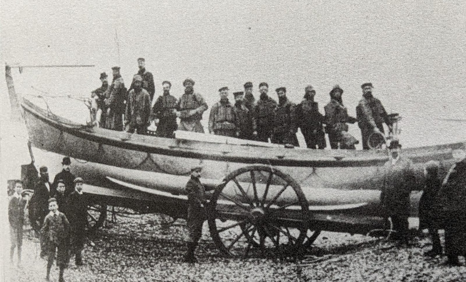A black and white photo of an open rowing boat as used in the 1890's