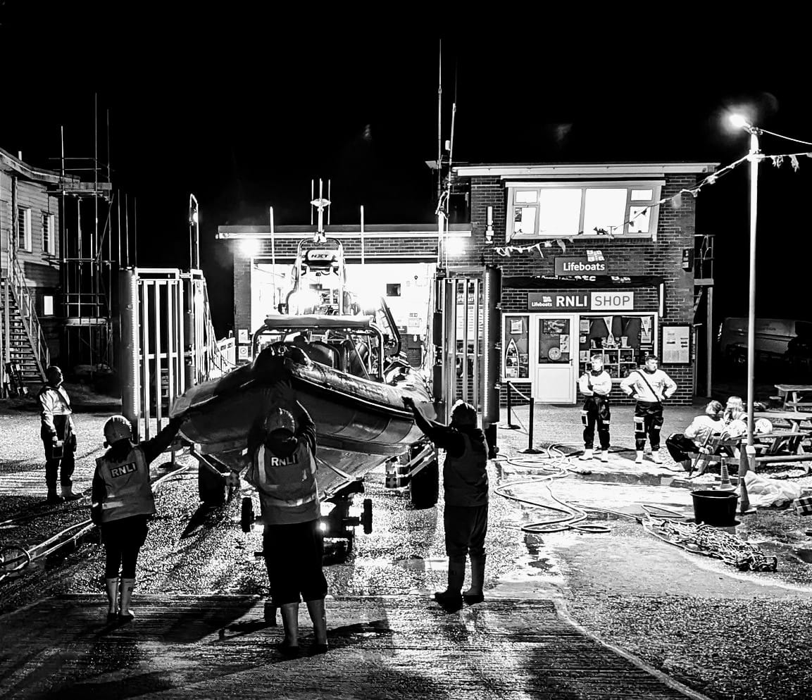 A black and white picture of the lifeboat being readied for service after a shout at night