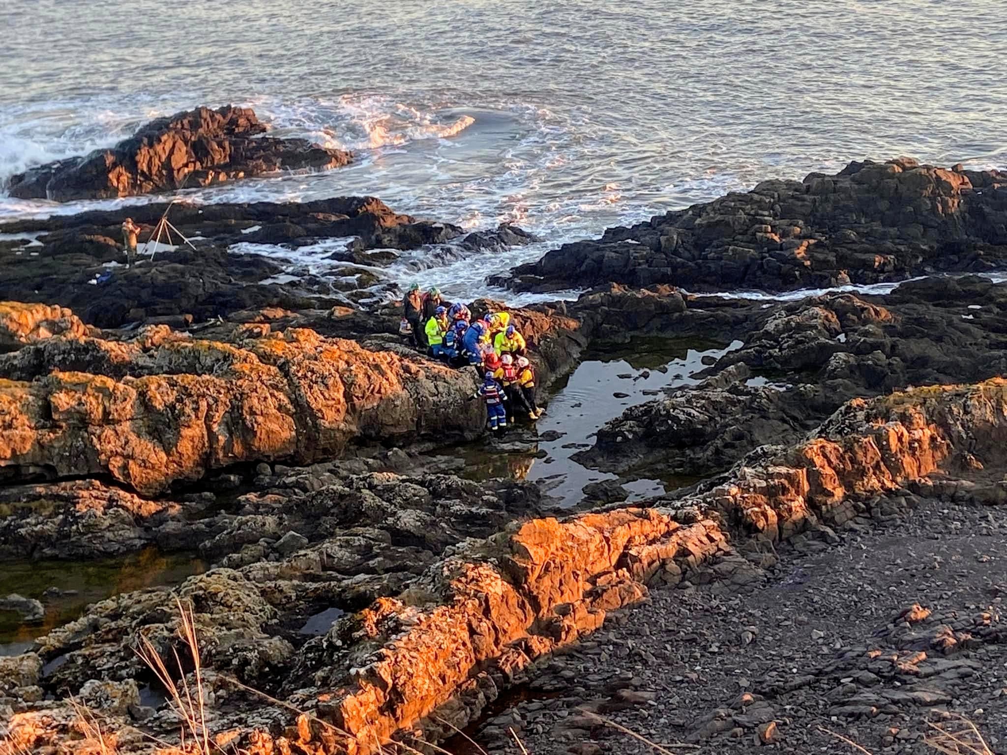 Montrose RNLI ILB volunteer crew assist with evacuation of casualty to air ambulance.