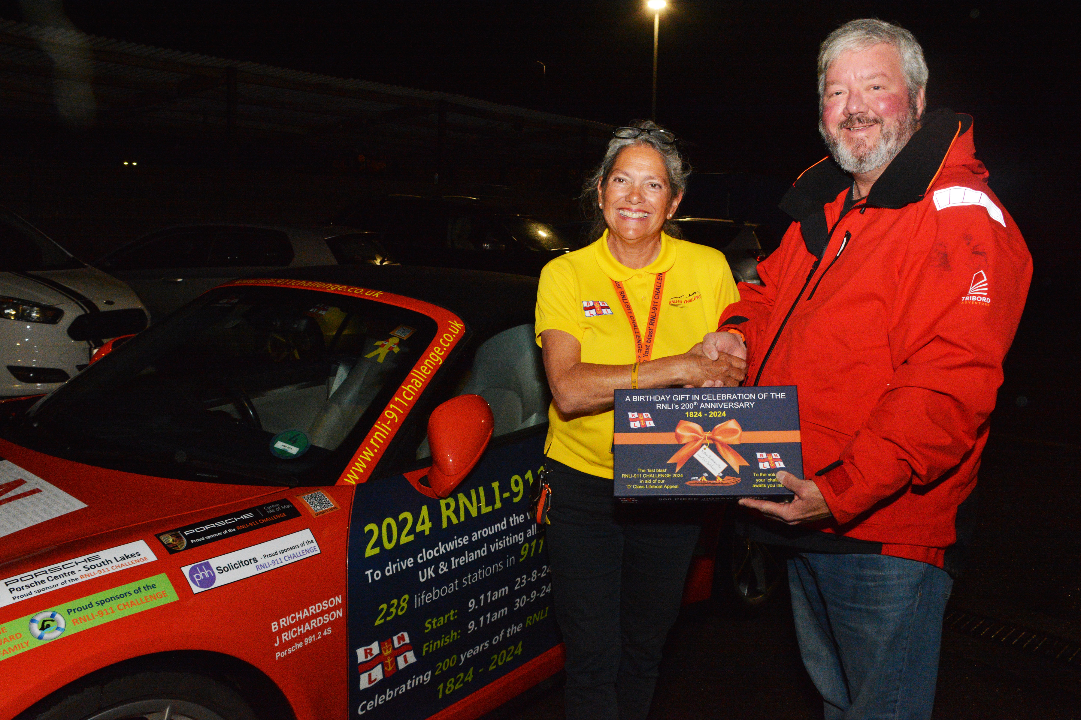 Belinda Richardson presents a sponsored gift to Lifeboat Operations Manager Matt Davies