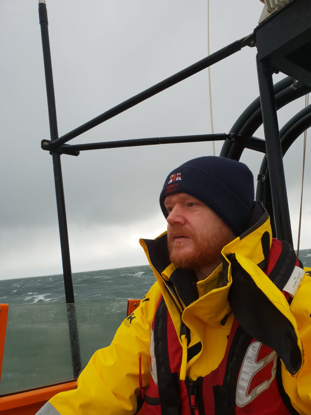 Man helming boat.