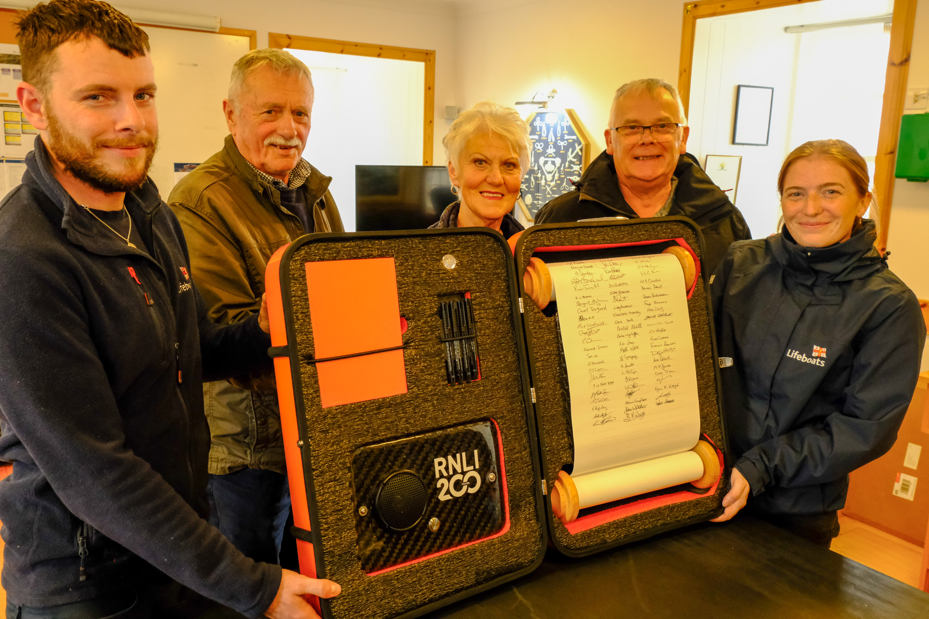 Signatories to the RNLI 200 Scroll (l to r) Stephen Manson, Coxswain; Hewitt Clark MBE, former Coxswain; Rhoda Watt, Treasurer of the Fundraising Committee; and John Webster, Branch Chairman. Also pictured - Charlotte Hill, of the RNLI's Bicentenary Team.