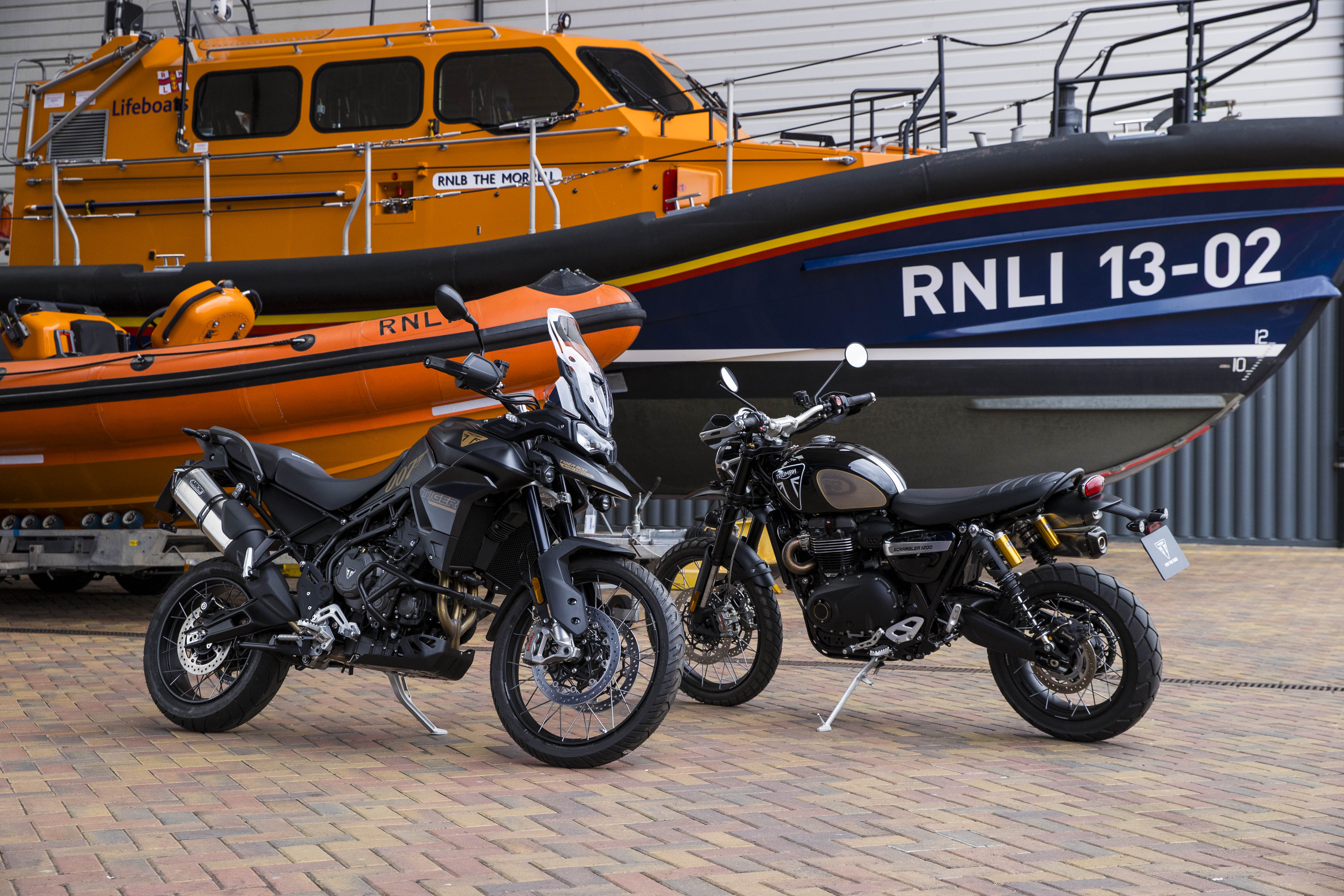 Daniel Craig's motorbikes in front of a Shannon class lifeboat and an Atlantic 85 lifeboat