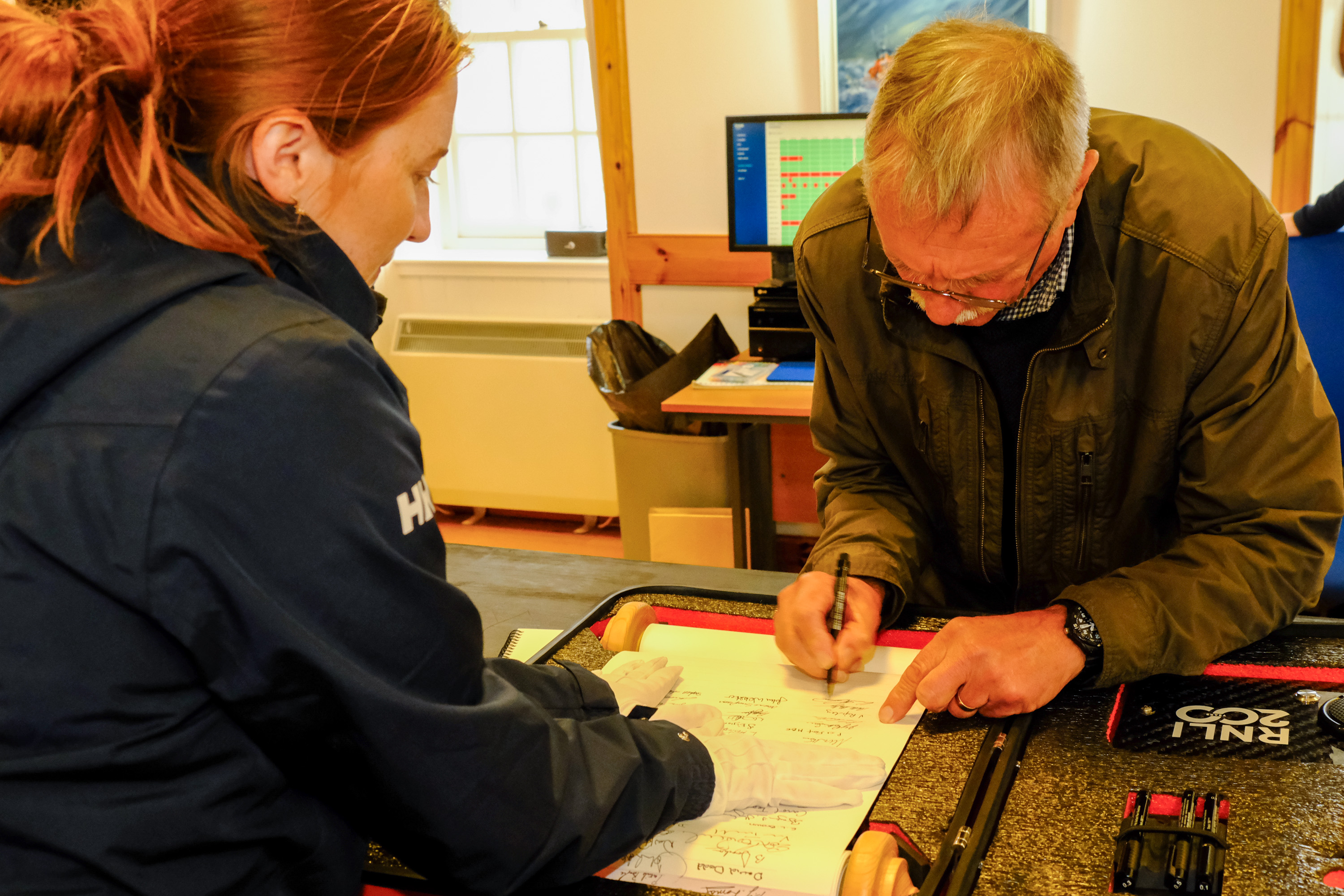 Hewitt Clark signs the RNLI 200th anniversary scroll in Lerwick