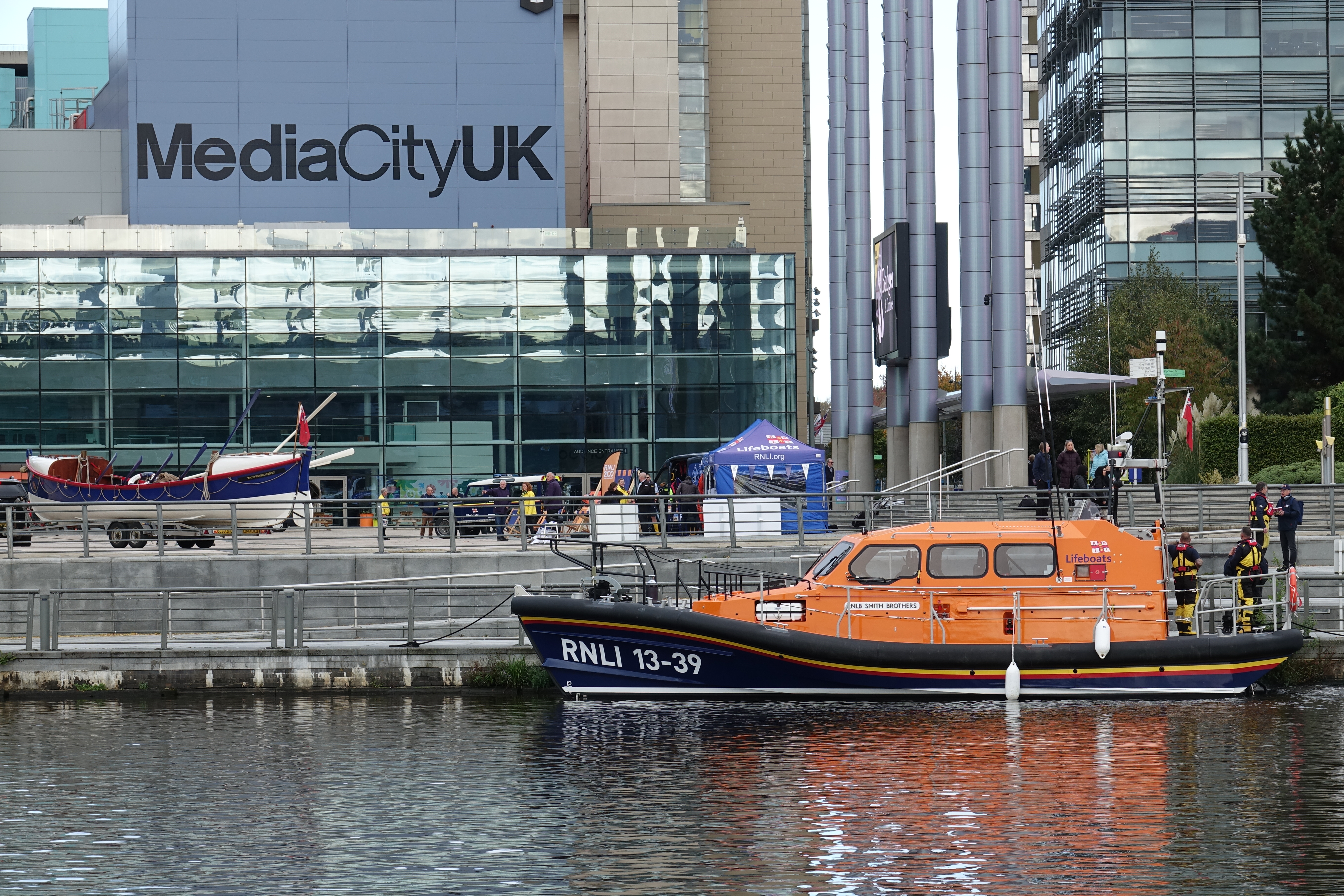 Pwllheli Shannon class all-weather lifeboat Smith Brothers 13-39 moored at Salford Quay in front of Media City UK building