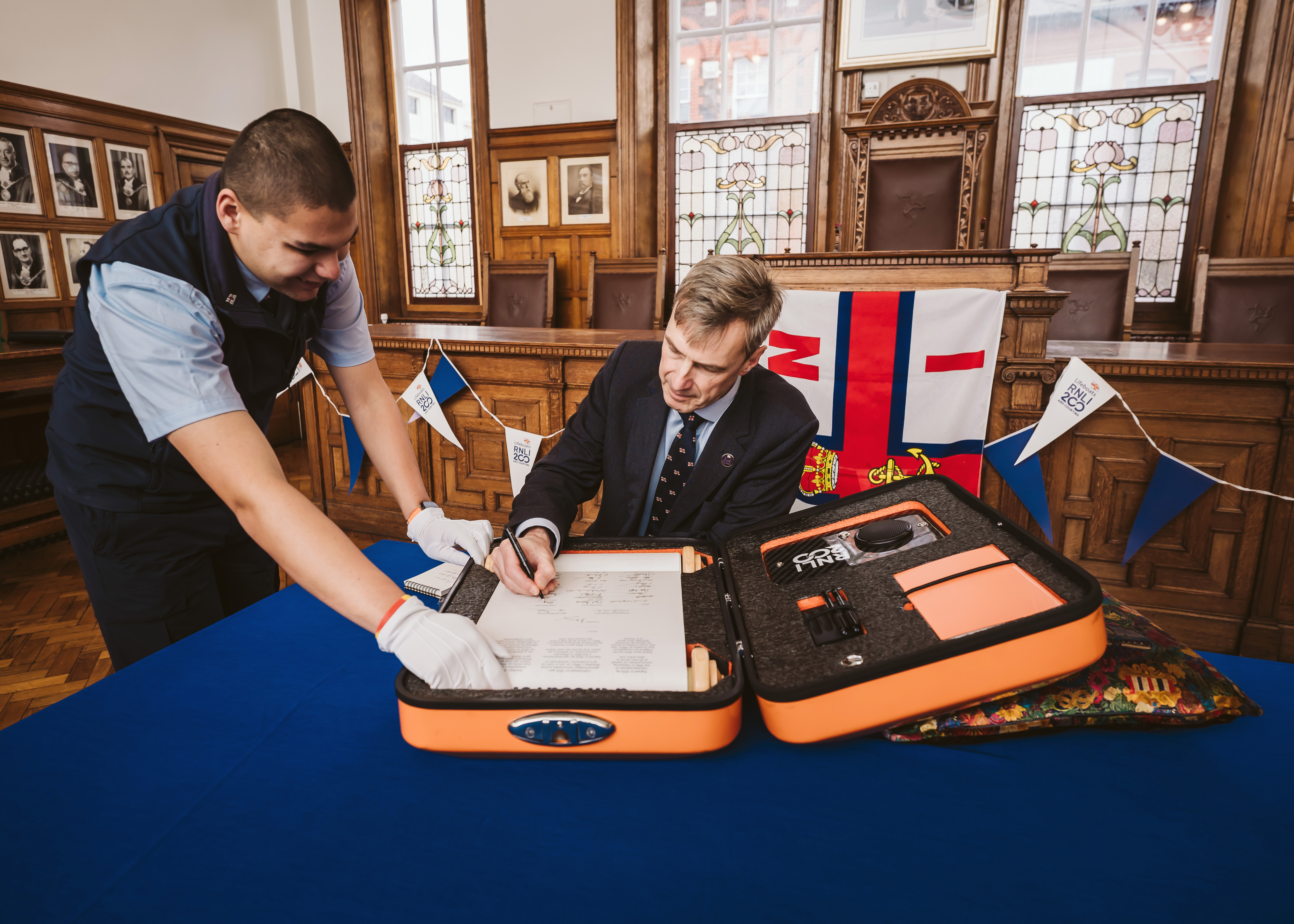 RNLI Chief Executive Peter Sparkes adding his signature 