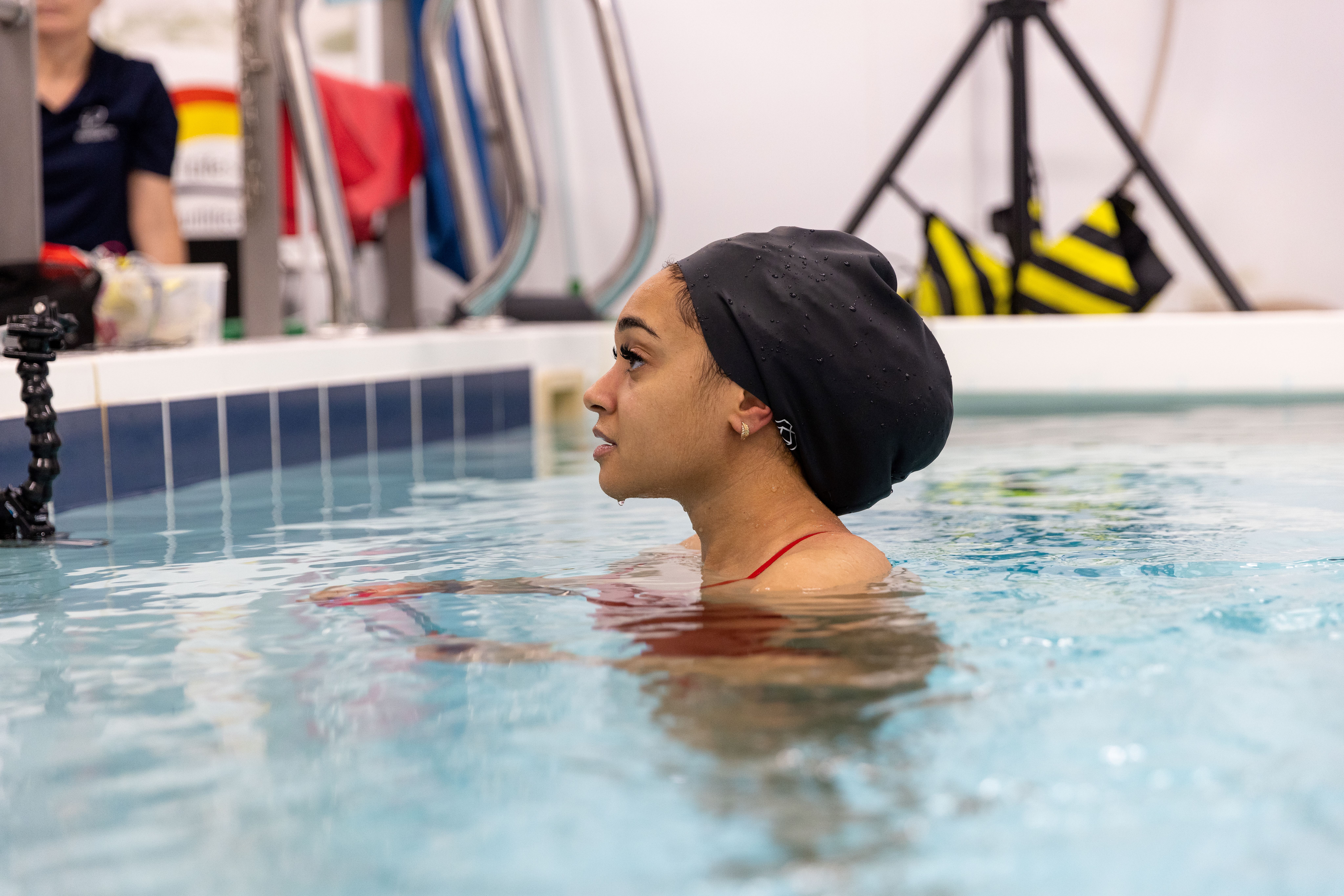 Team GB Olympic marathon swimmer and BSA co-founder Alice Dearing upright in the pool submerged to her shoulders.