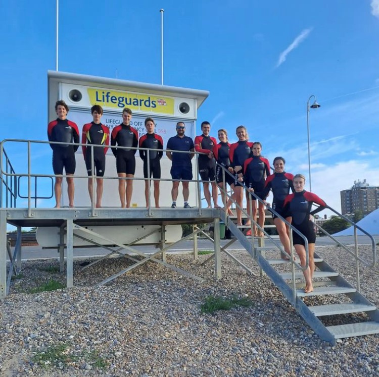 West Sussex and Hampshire Lifeguard Team 2024 in front of lifeguard hut