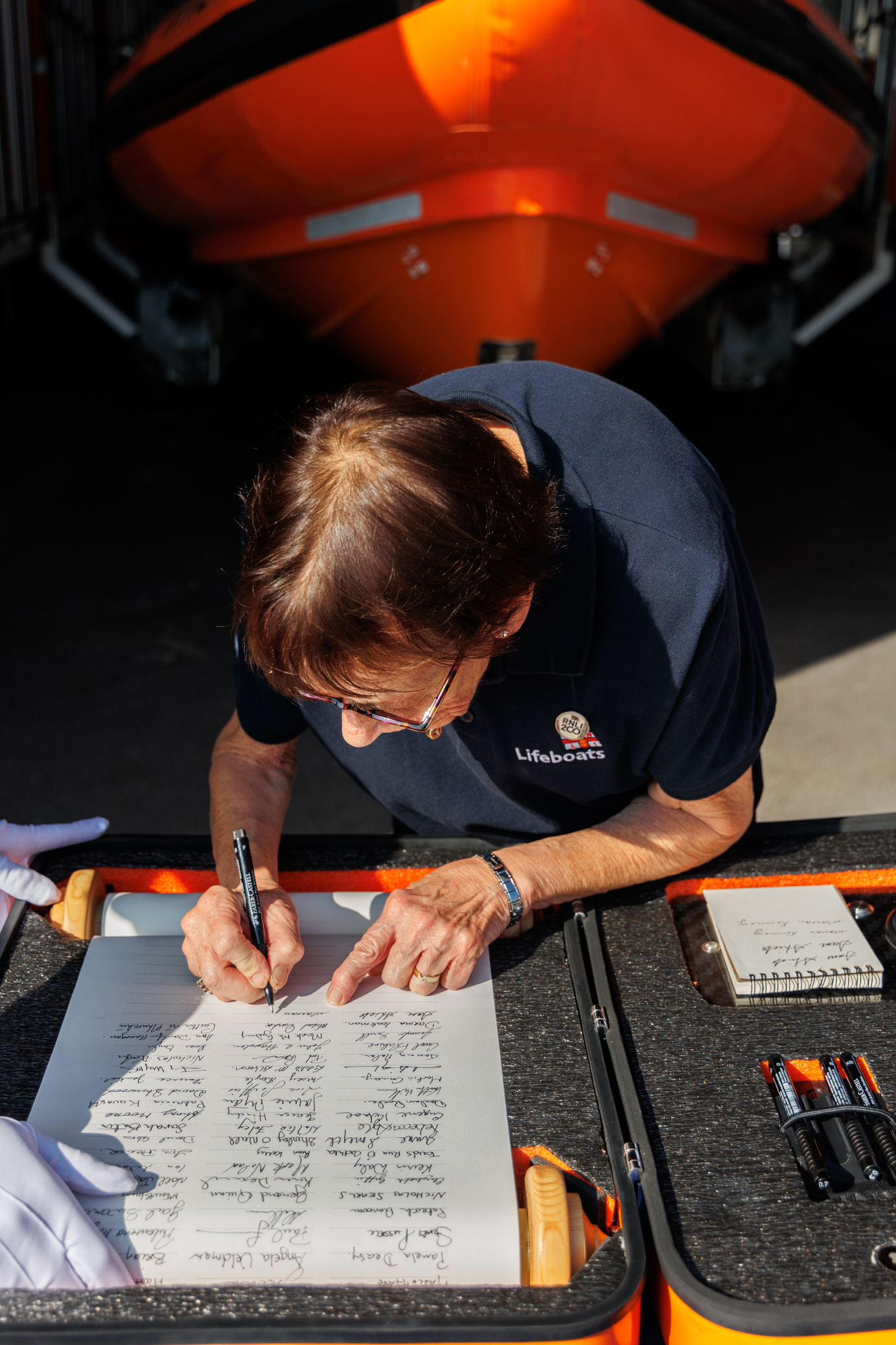 Marian Kennedy signing the scroll