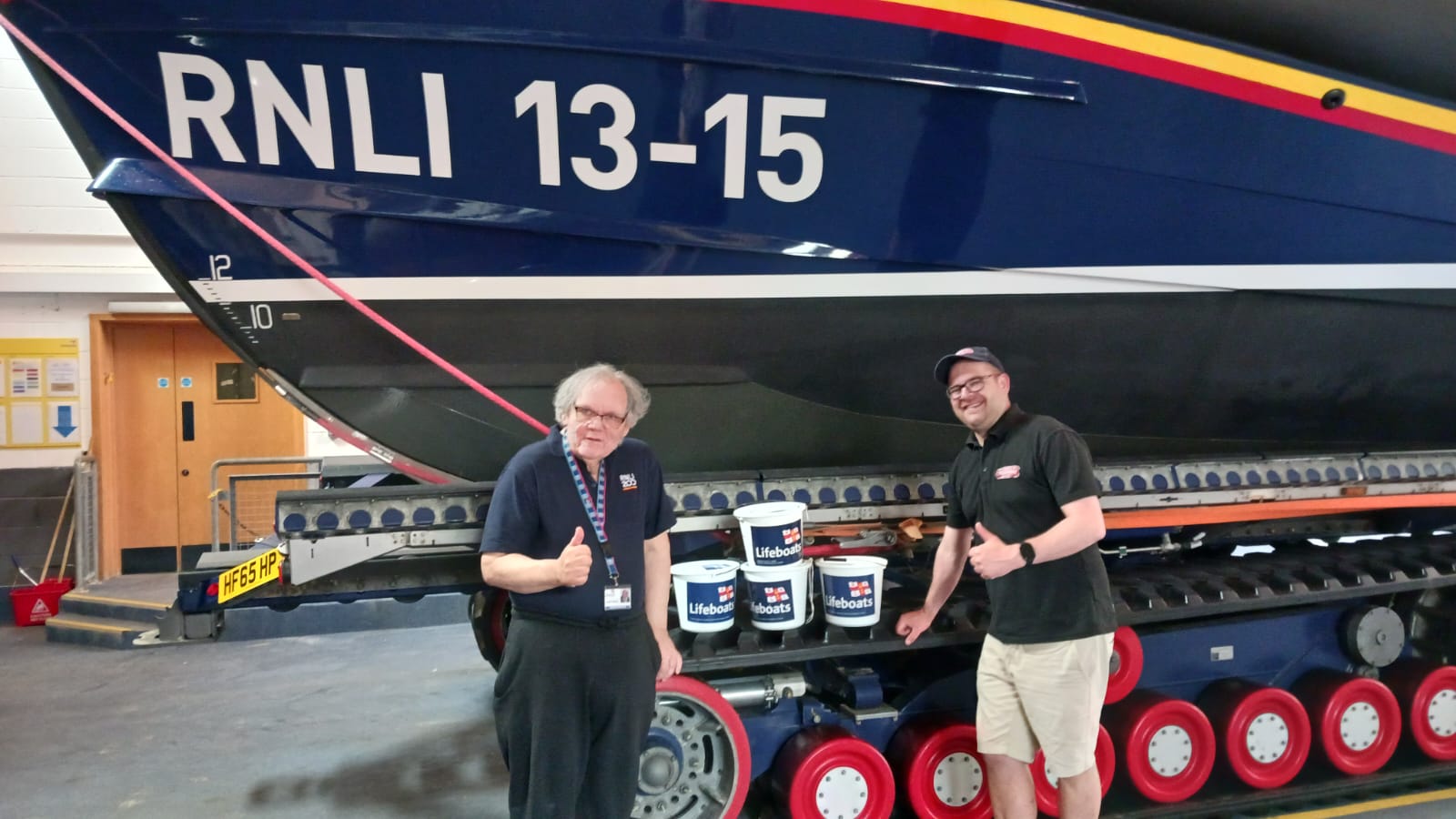 Scarborough RNLI visits Officer John Porter with Central Tramway general manager Colin Powel standing in front of RNLI Scarborough all-weather lifeboat