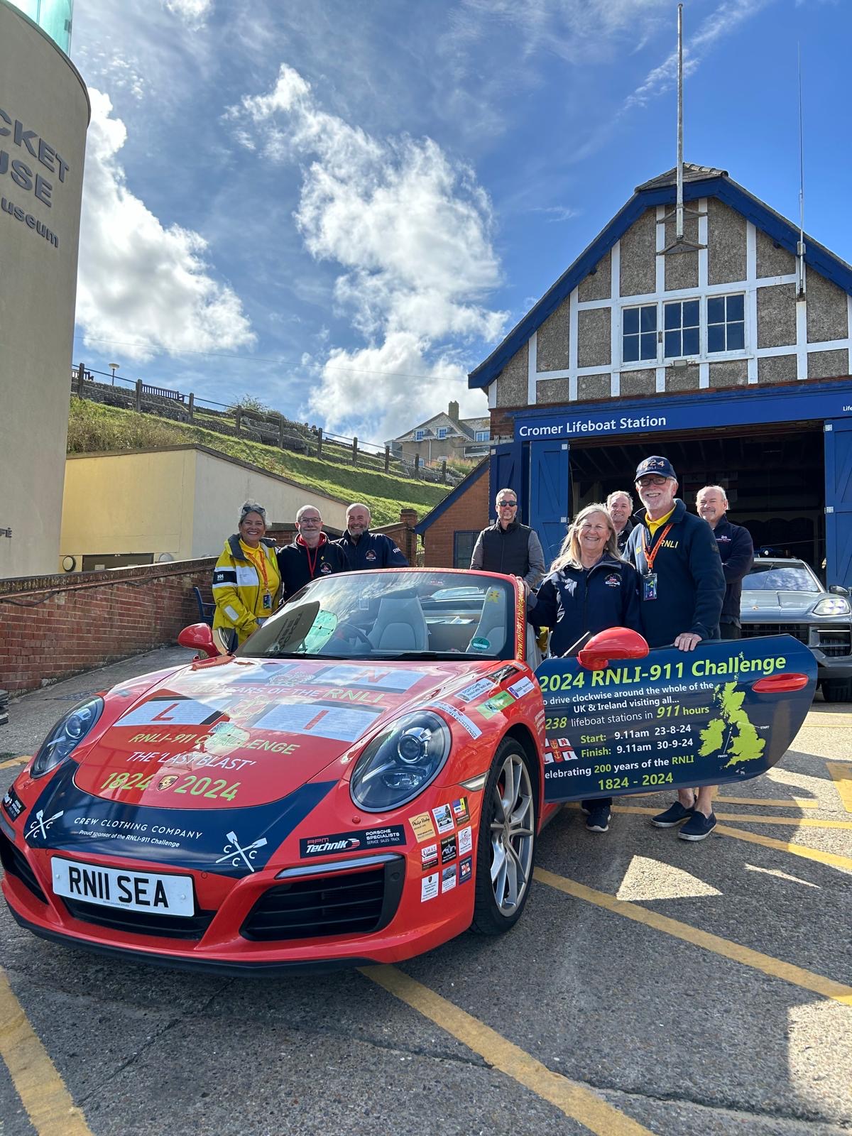 Belinda and James Richardson meeting Cromer RNLI Volunteers at Cromer inshore lifeboat station in their Porsche 911