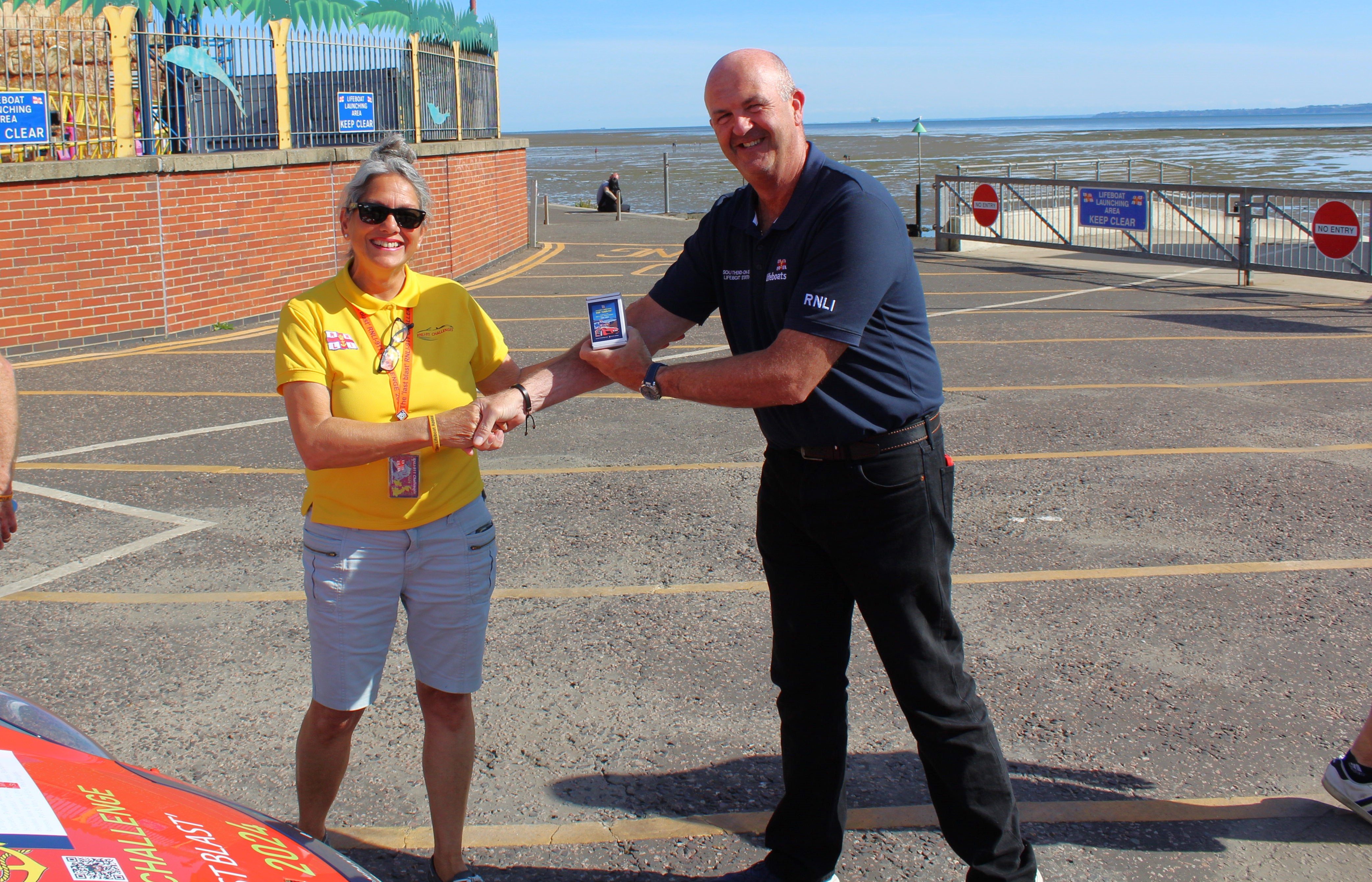 Belinda Richardson presenting volunteer Nick Elmore with a unique gift pack of cards