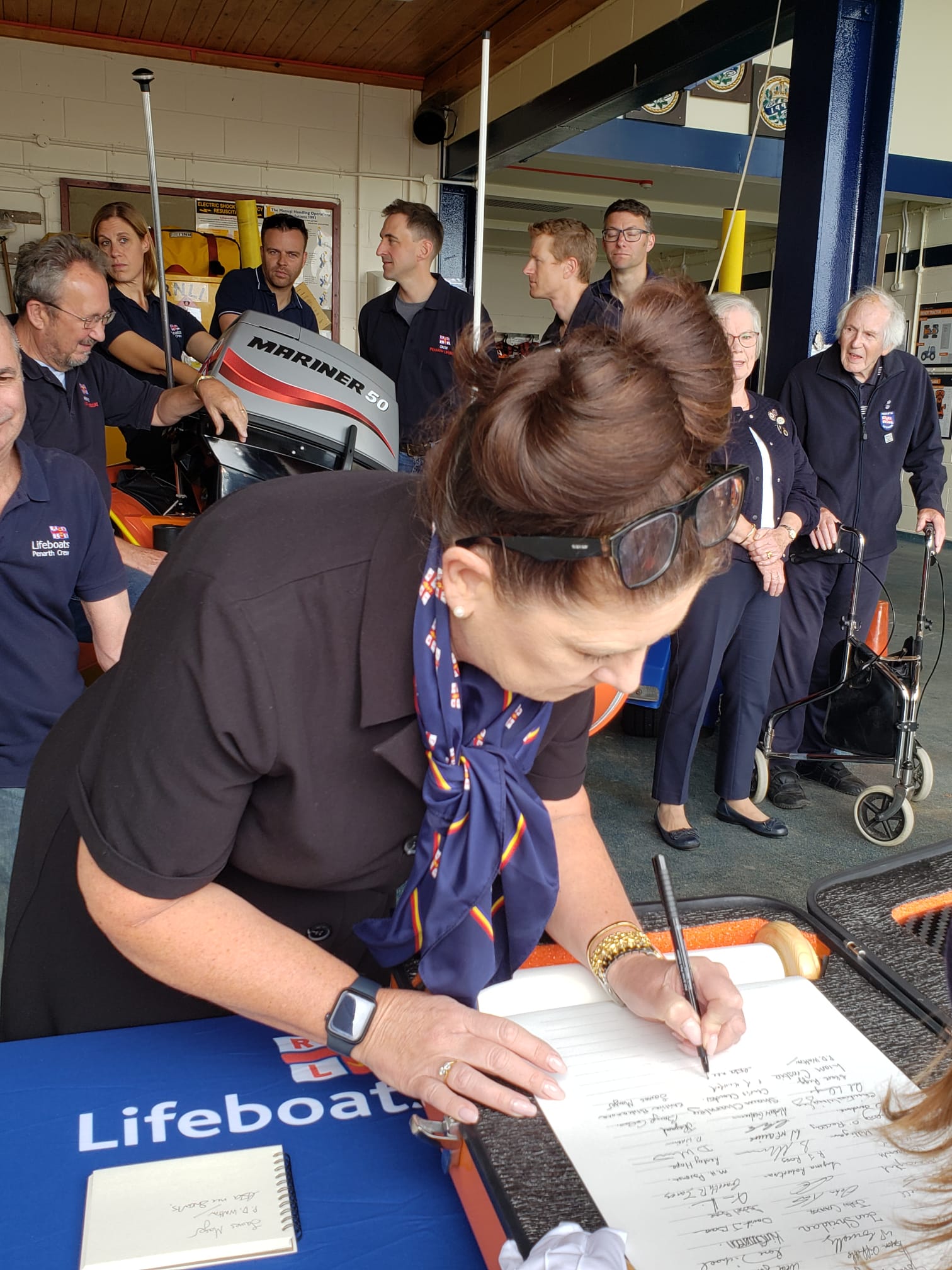 Caroline Eva chairperson for fundraising at Penarth signing the Scroll