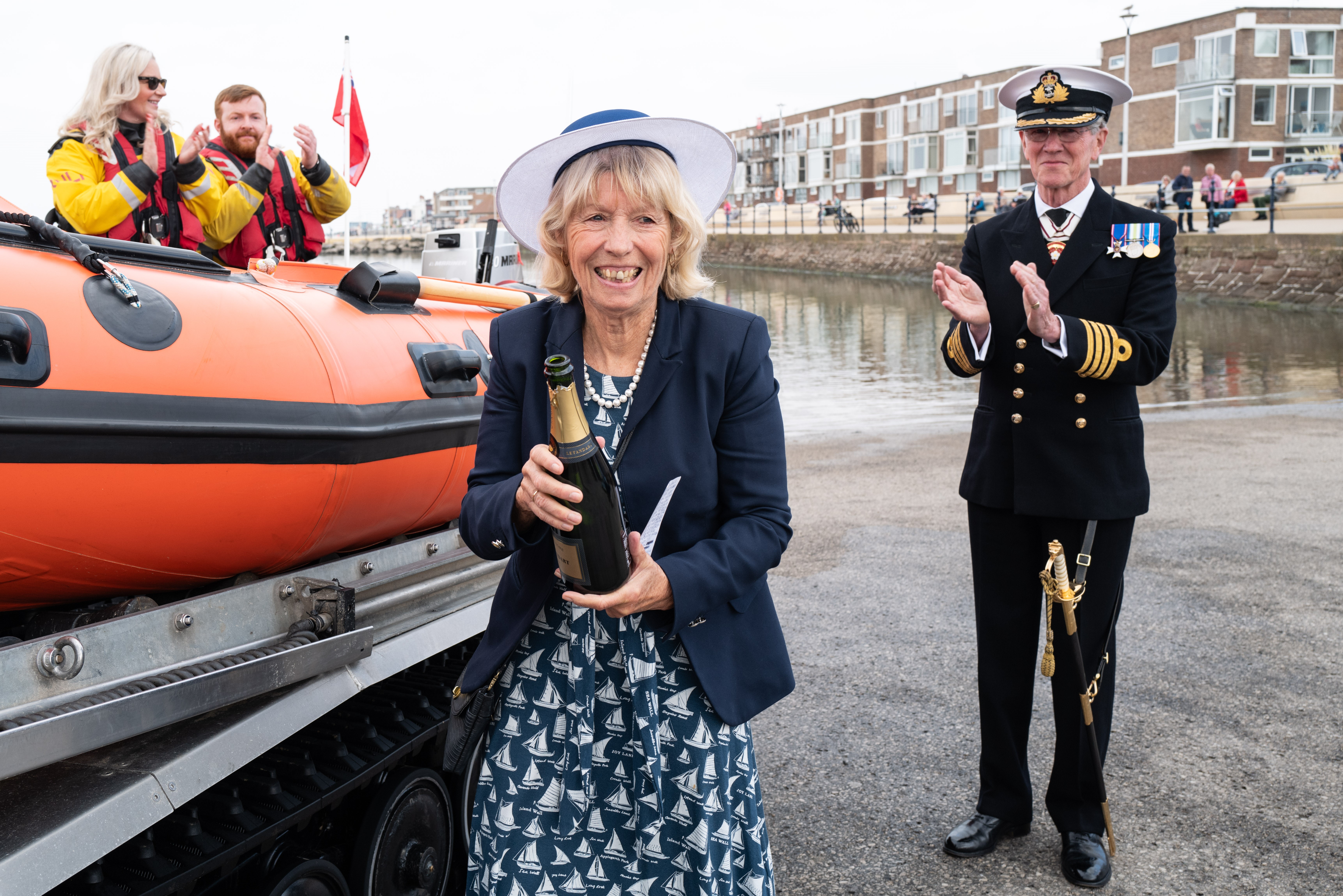 Mrs Valerie Daglish BA is pictured with the champagne used to spray over the new boat with Captain Hugh Daglish LVO JP DL RN