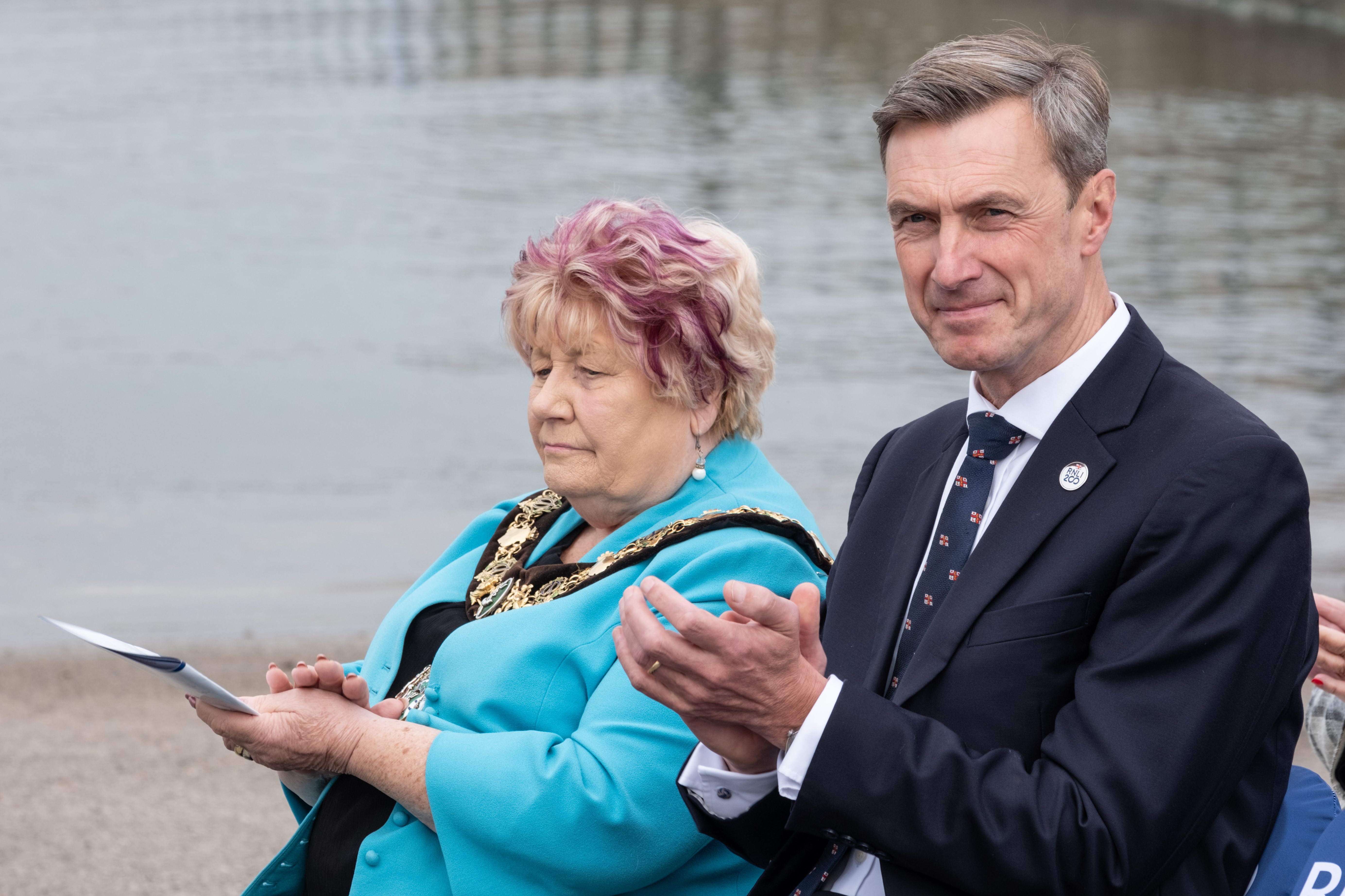 The Mayor of Wirral Councillor Cherry Povall JP sat next to Peter Sparkes, RNLI Chief Executive as they watch the event