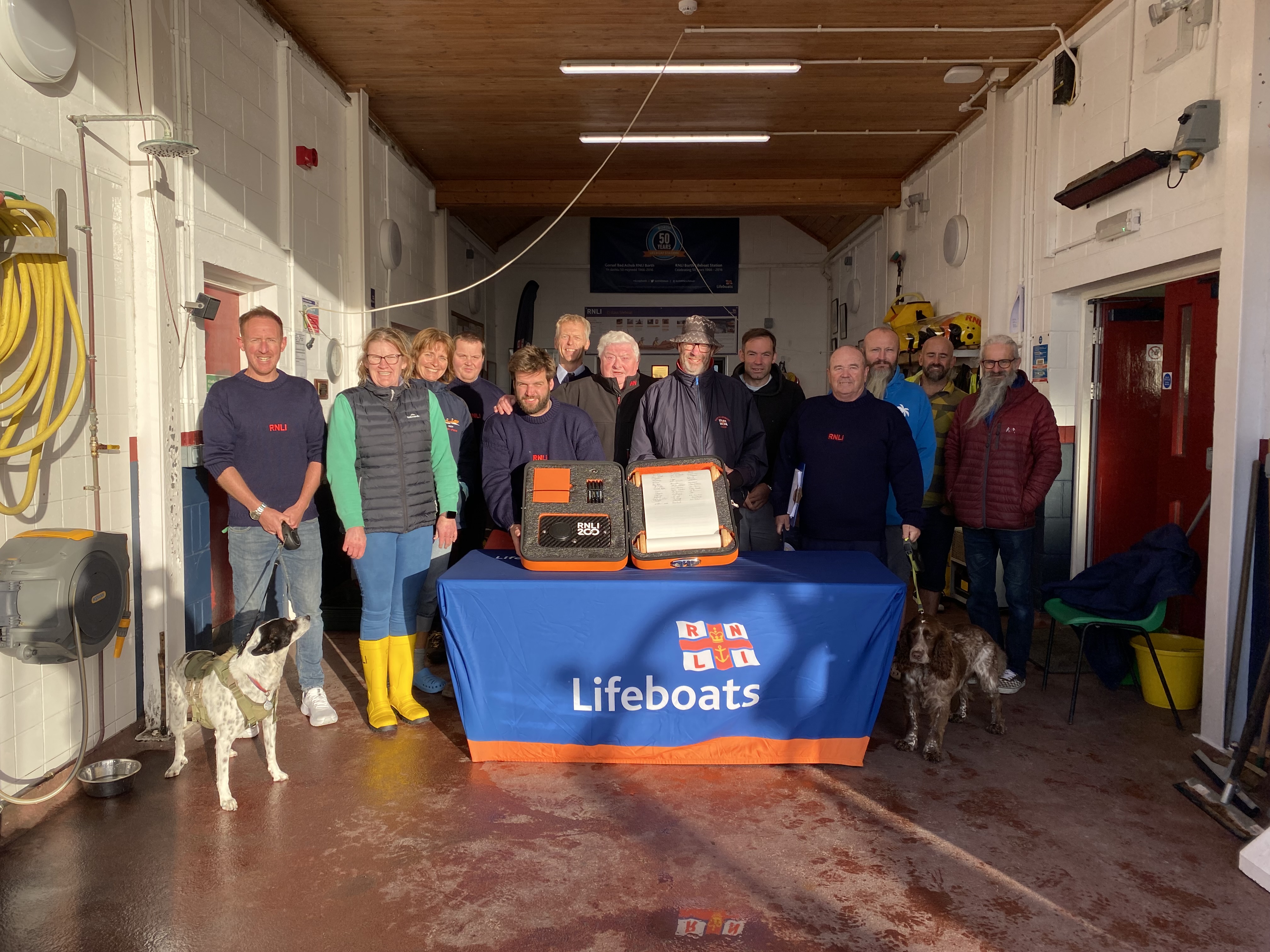Members of Borth RNLI at the station with the newly signed RNLI 200 scroll
