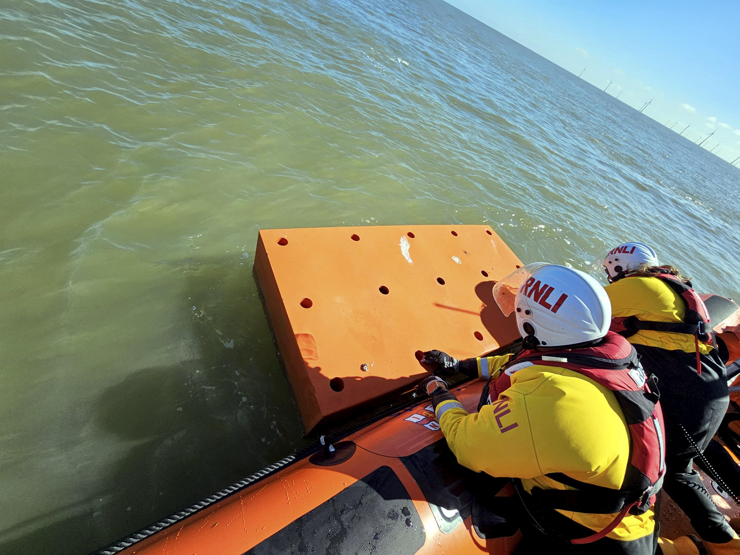 Debris is recovered to the lifeboat during Monday's search.