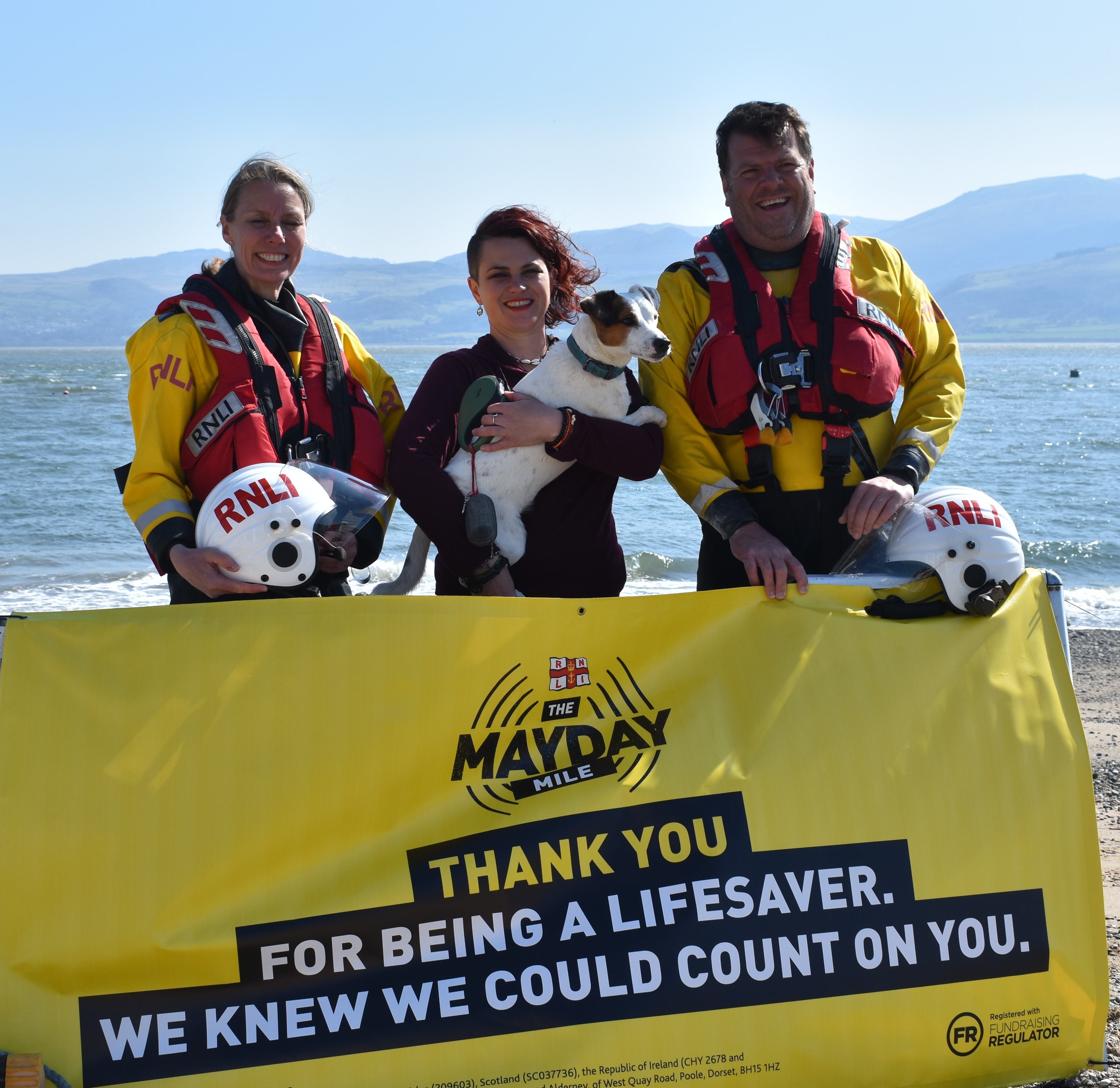 Gwen, Emily and Tim at Beaumaris Lifeboat Station with Mayday poster.