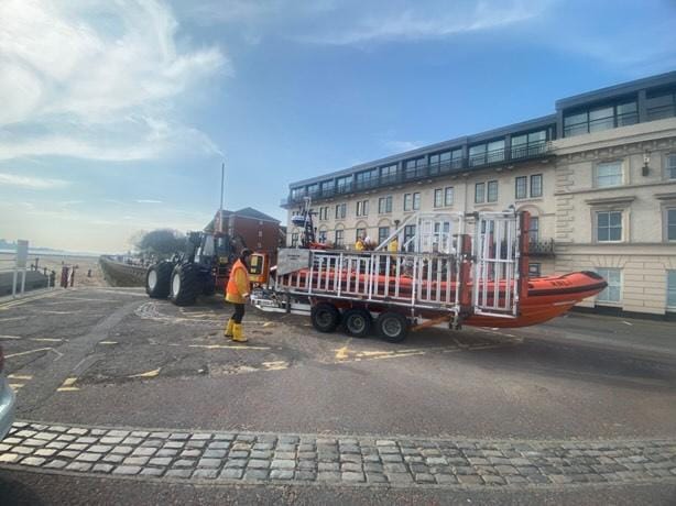New Brighton boat and shore crew prepare the boat to be launched at the top of the slipway. Tractor can be seen, ready to go, ahead of the carriage.