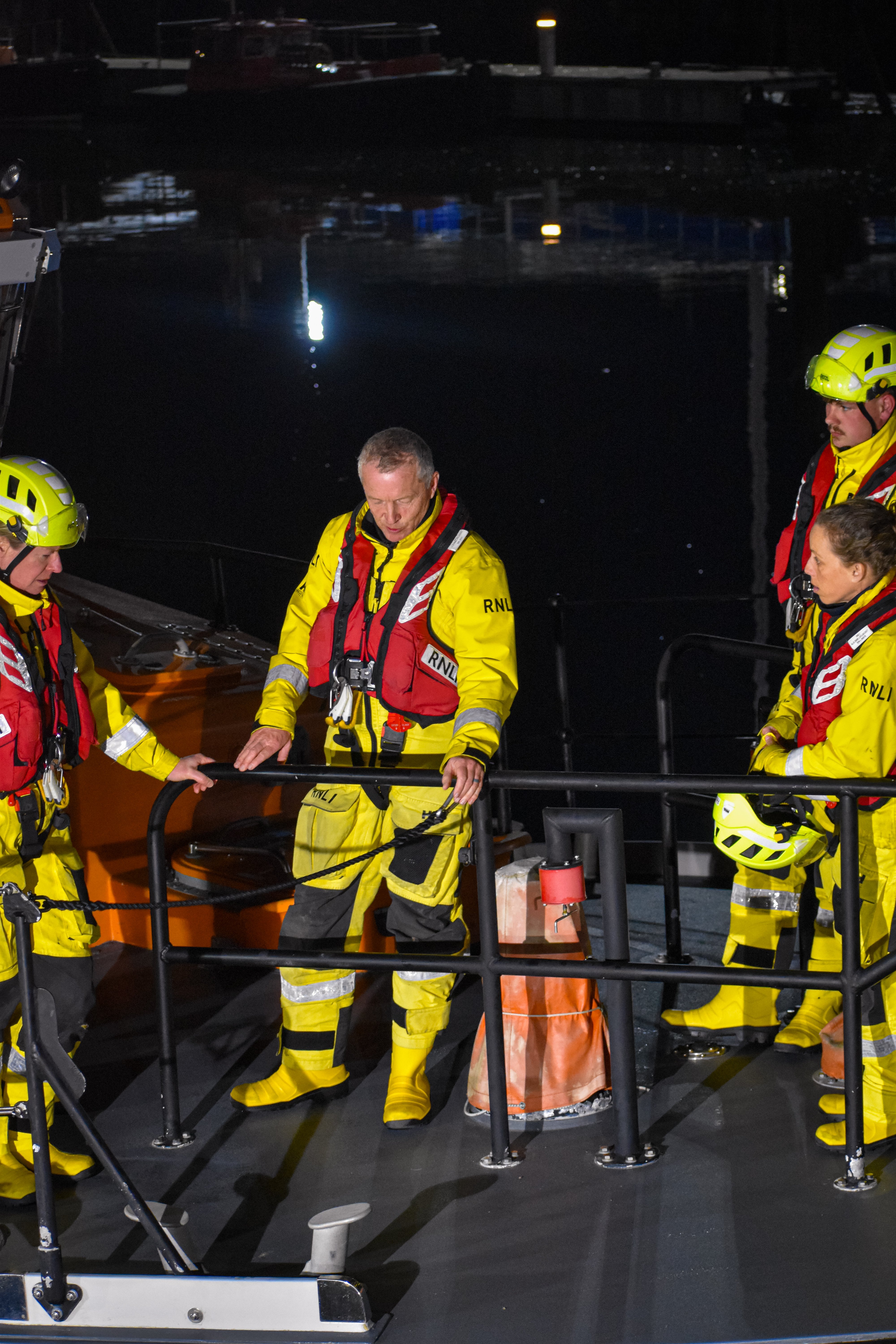 John with other crew members standing around during a training session