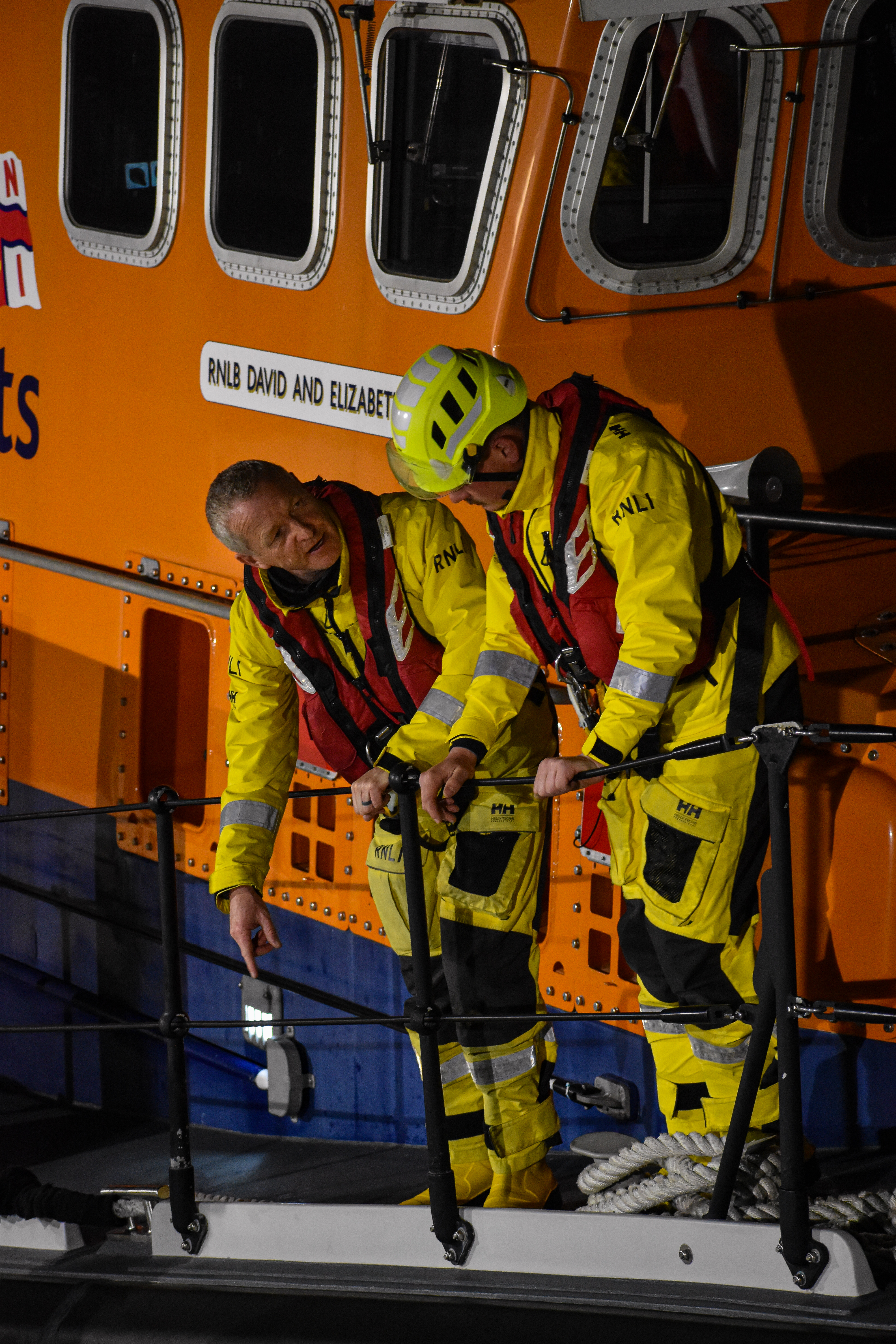John standing next to another crew member during a training session.