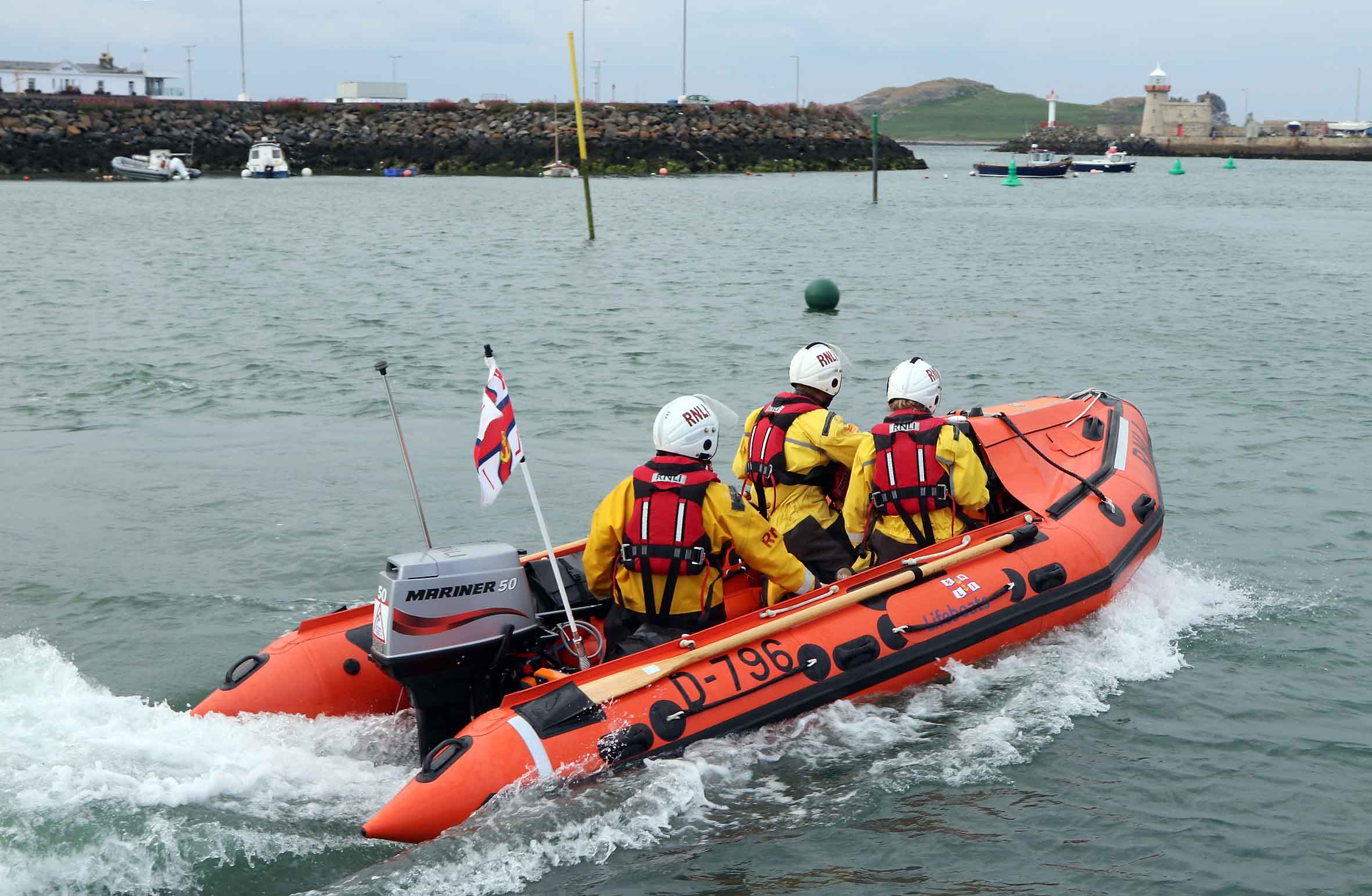 Stock photo - Howth RNLI inshore lifeboat underway in Howth Harbour.