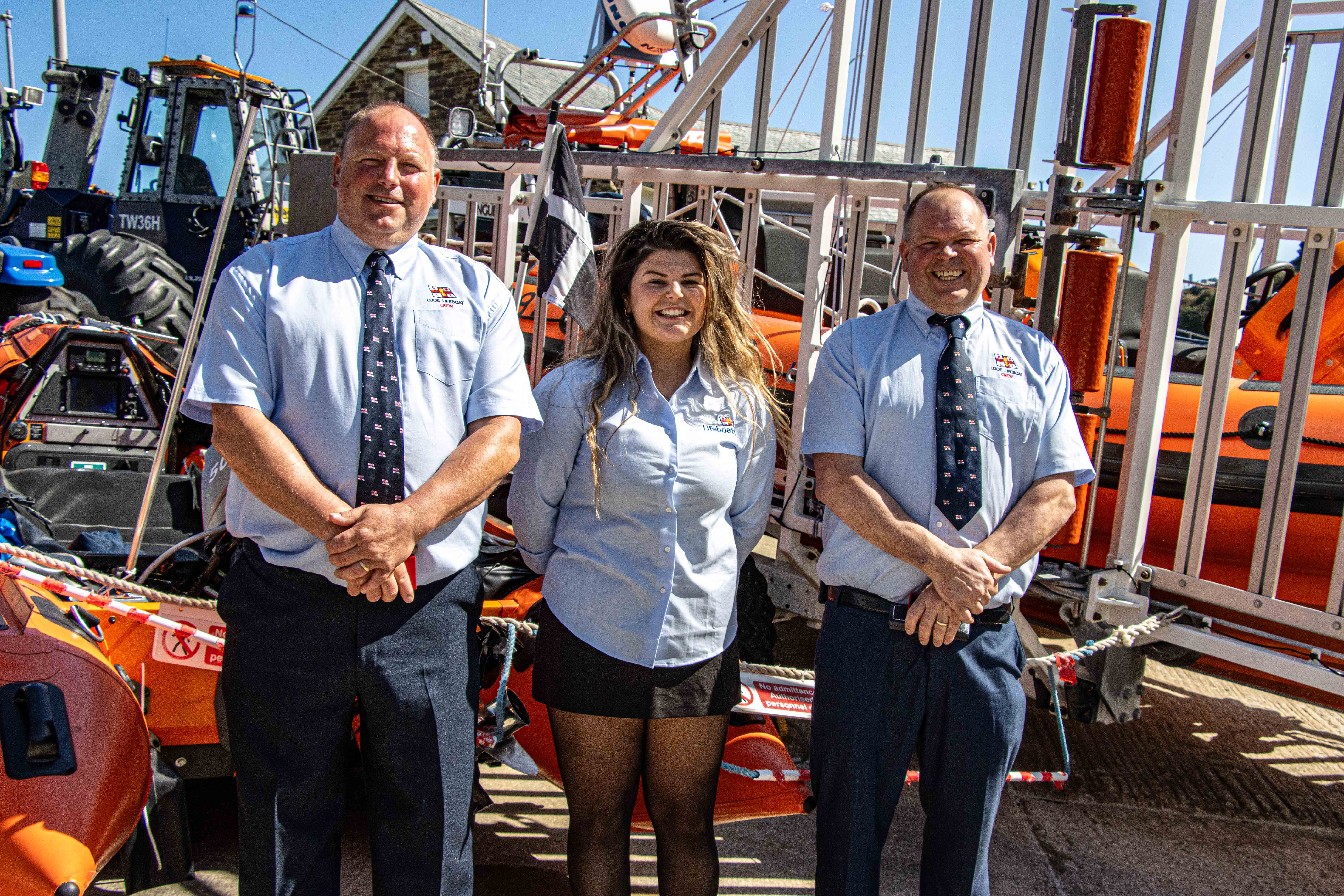Del Palfrey, Amber Palfrey and Clive Palfrey standing next to the charity’s inshore lifeboats