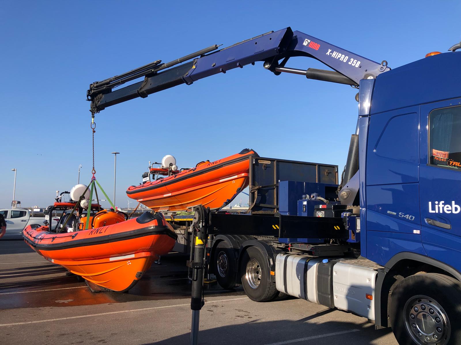 Two B-class lifeboats can be seen to the side of the road transport truck, ready to be swapped over.
