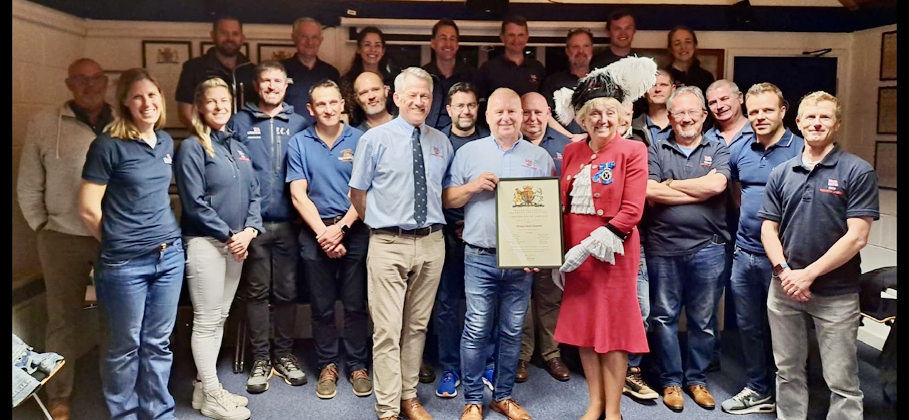 Mike being presented with a letter of thanks and long service award by Janey Howell and Philip Lay in front of the Penarth Crew
