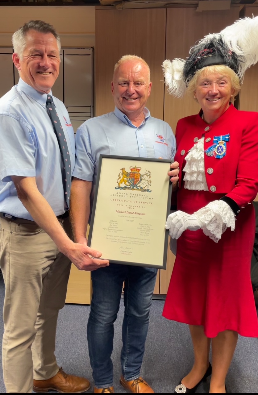 Portrait view of Mike being presented with long service award by the High Sheriff and LOM