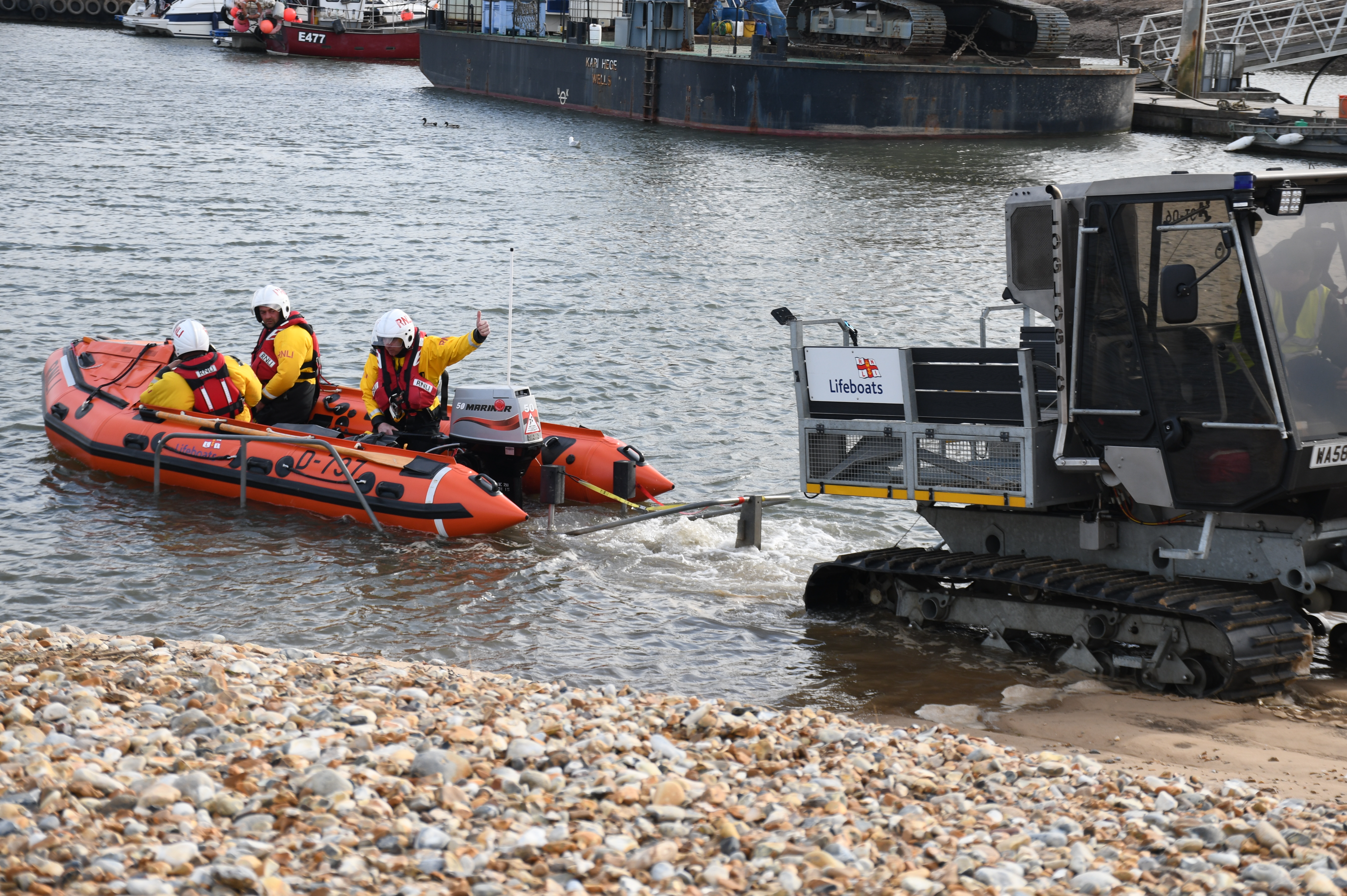 Wells RNLI launch in outer harbour to two people cut off by the tide with volunteer crew of three