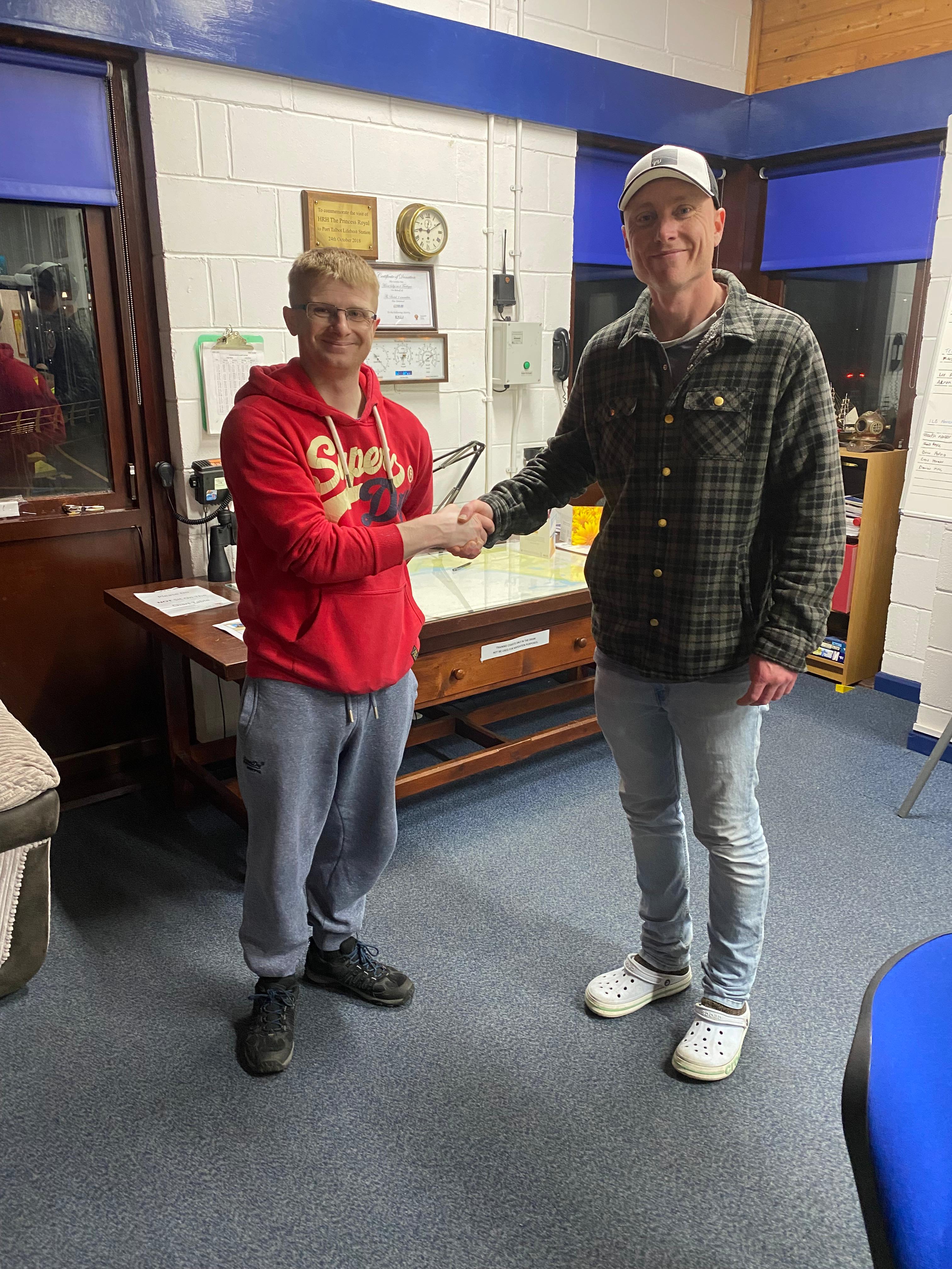 Port Talbot RNLI Paul Skinner congratulatory handshake for Tom Charles 