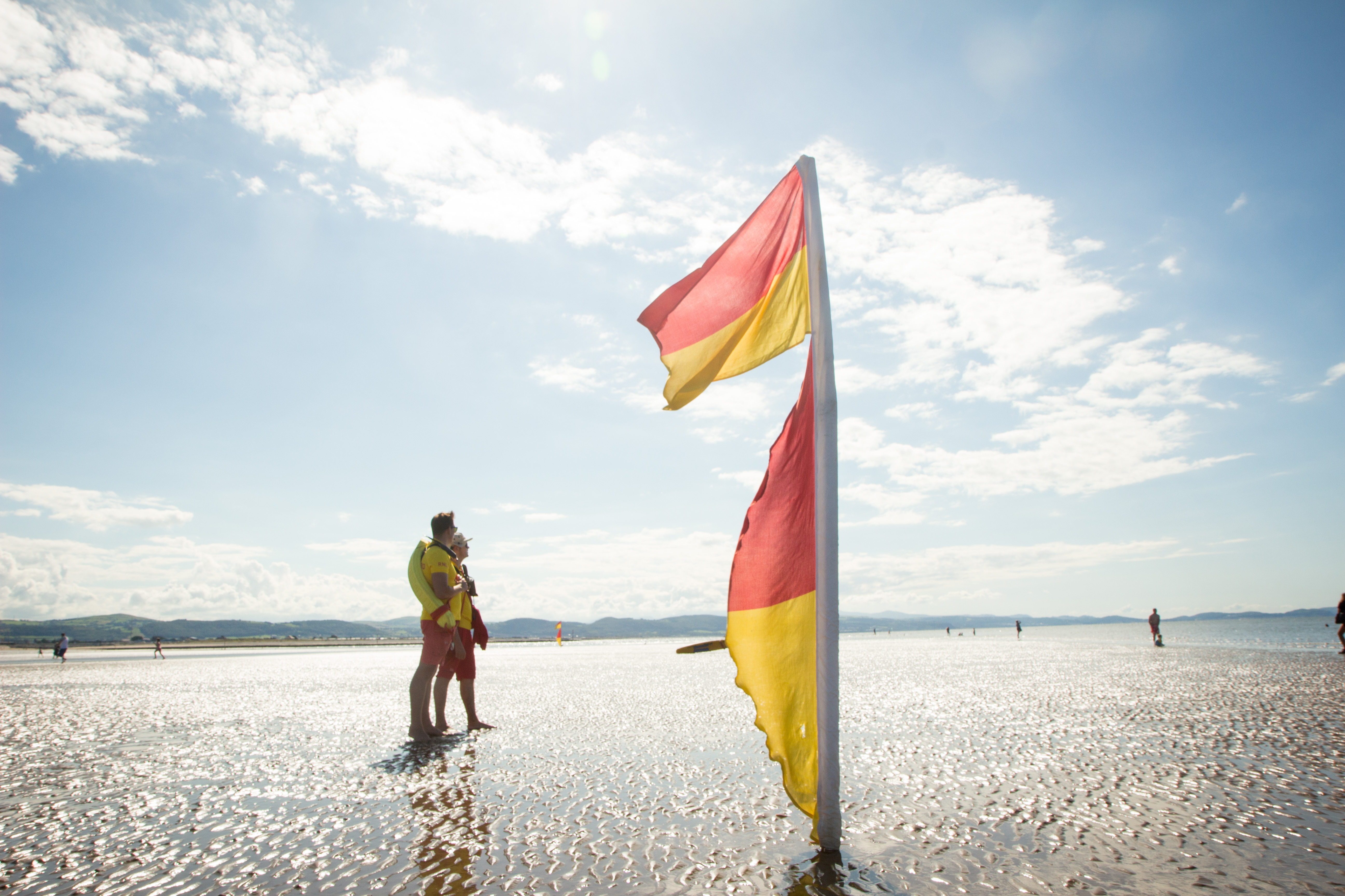 Two lifeguards keeping watch on a sandy beach