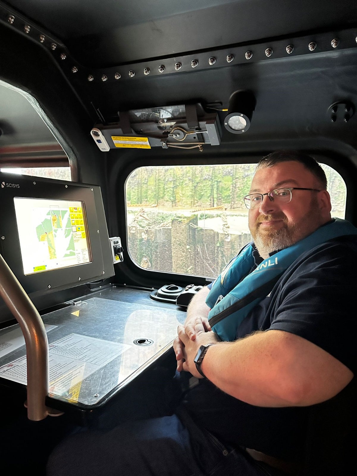 Andy Wilson at the navigator's workstation aboard a Shannon-class lifeboat.