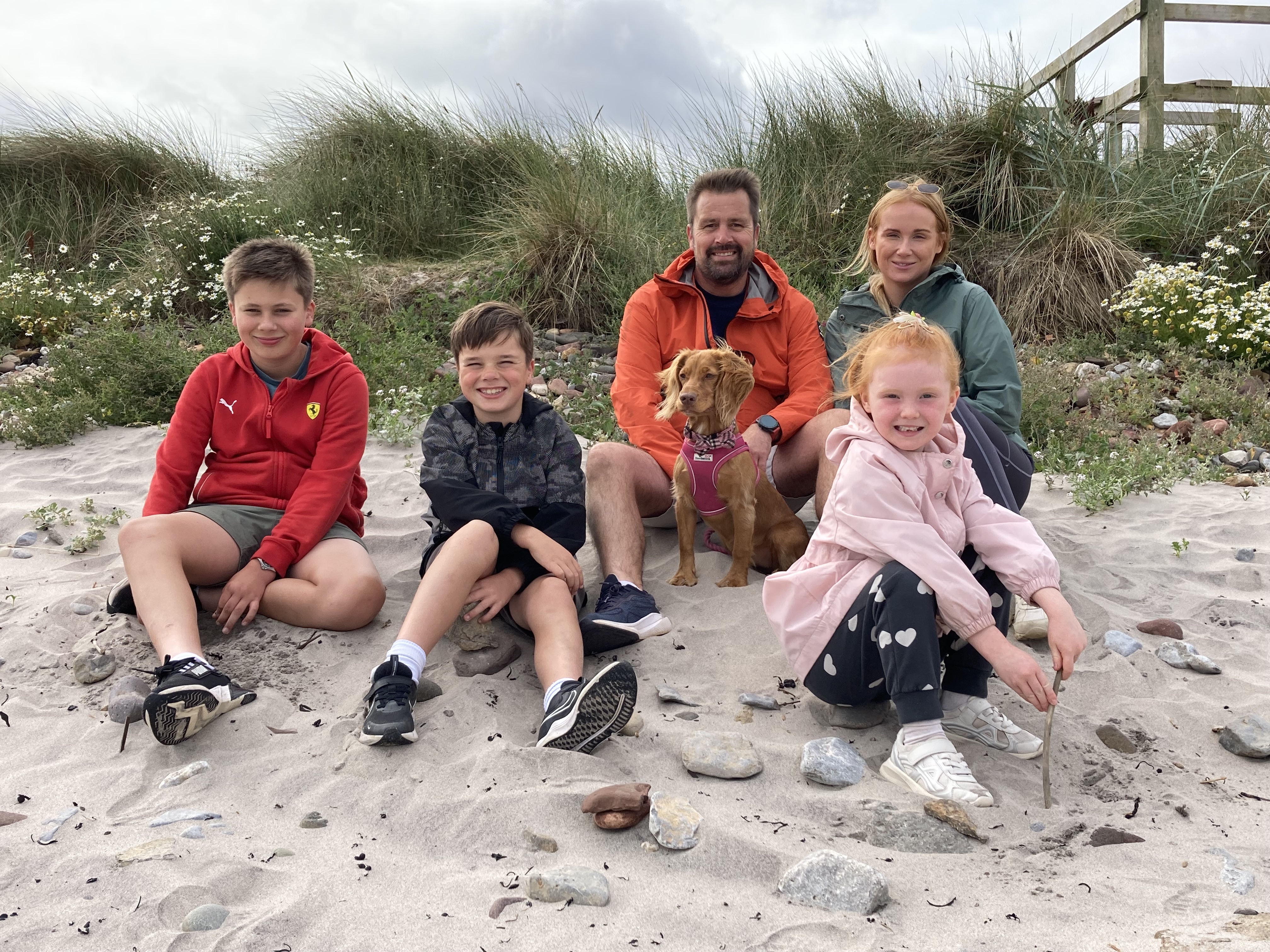 Five people on beach.