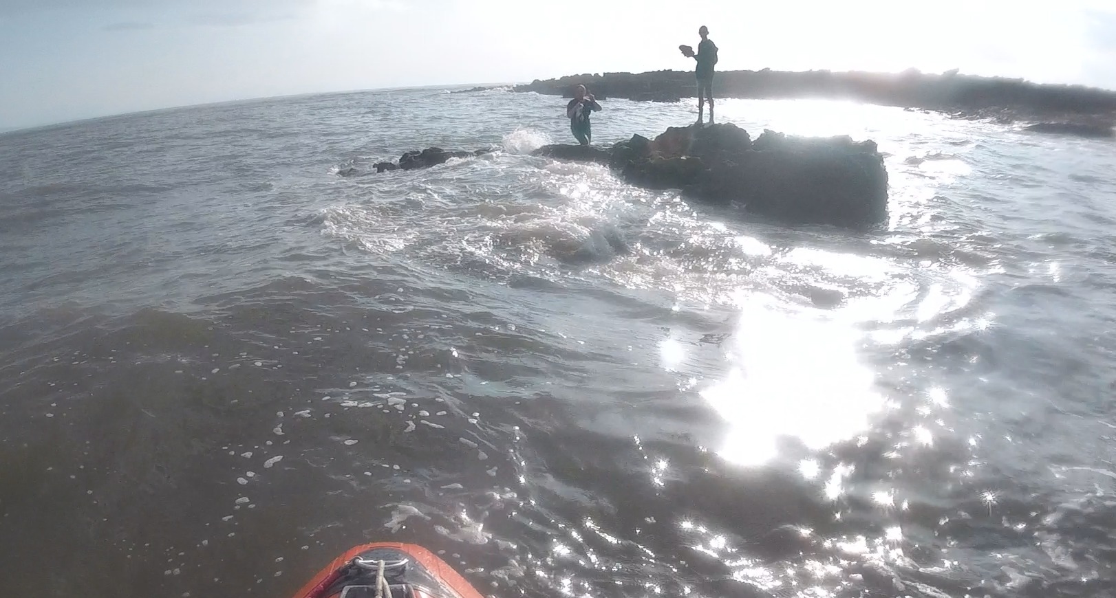 ILB approaching two people on rock