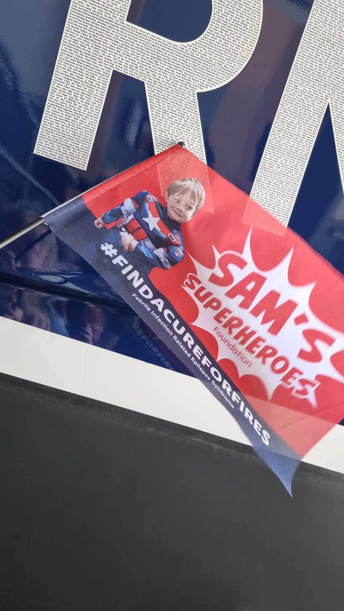Sam's Superheroes flag pointing to Sam's name in the decals of Wells RNLI Shannon class lifeboat
