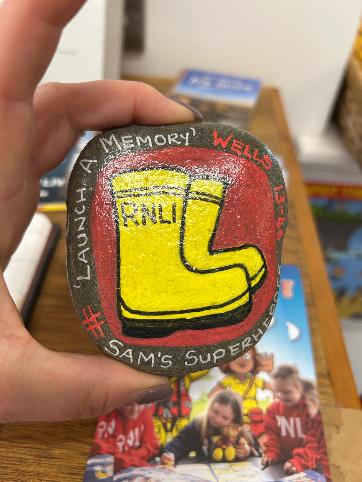 Painted stone launch a memory 13-46 with yellow wellies painted on it 