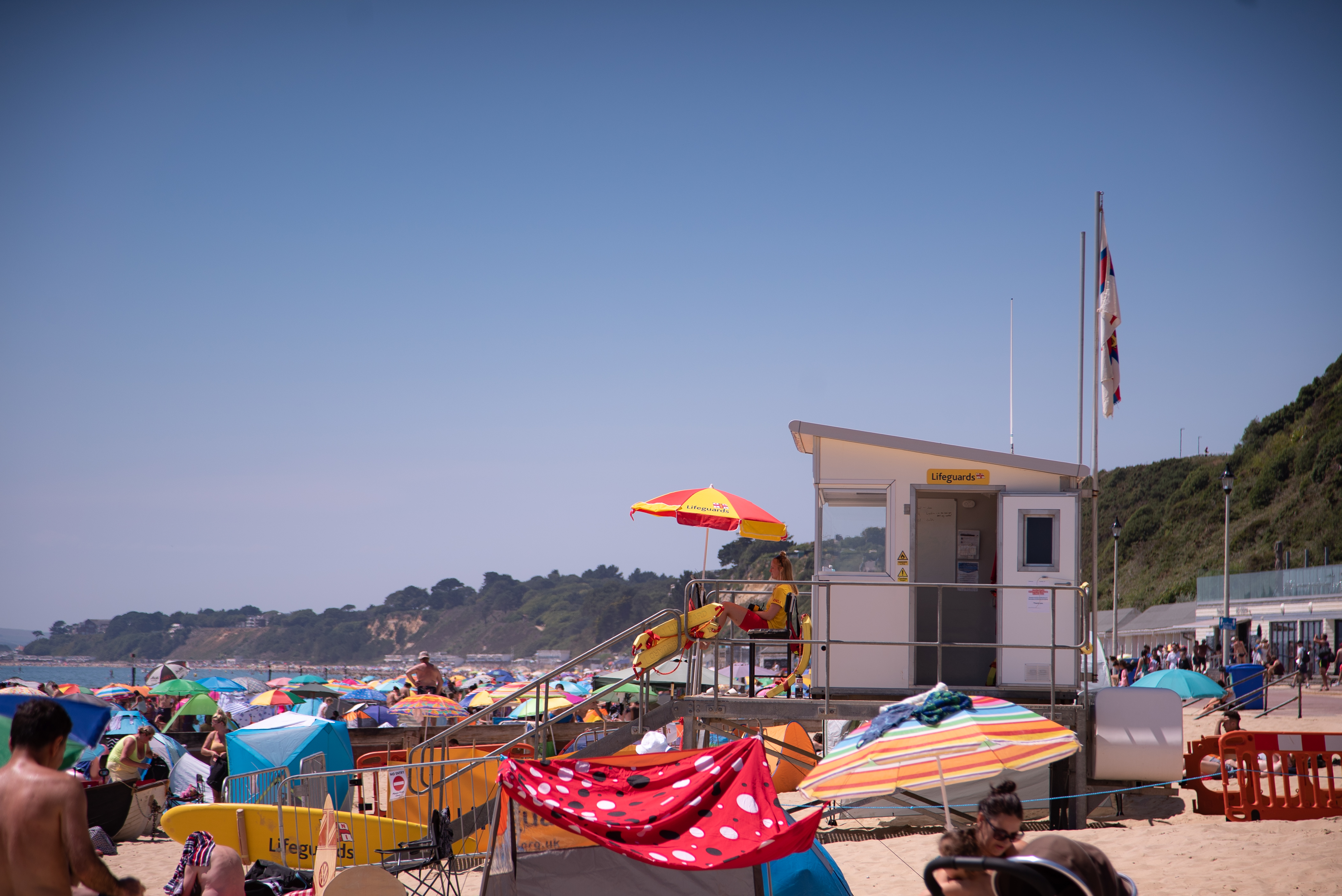 RNLI lifeguards look over a busy beach