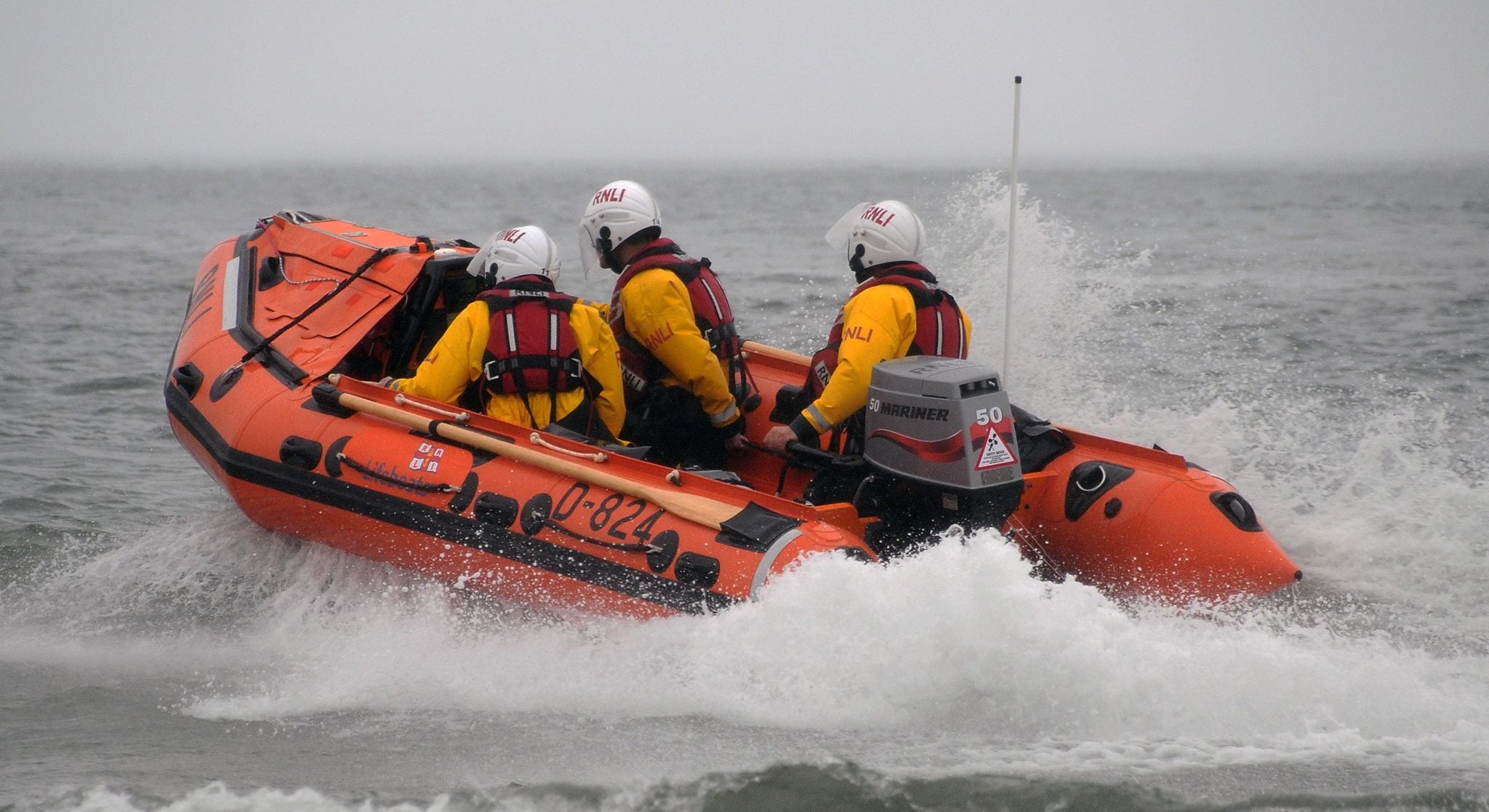 Horton's inshore lifeboat with three crew moving through the sea