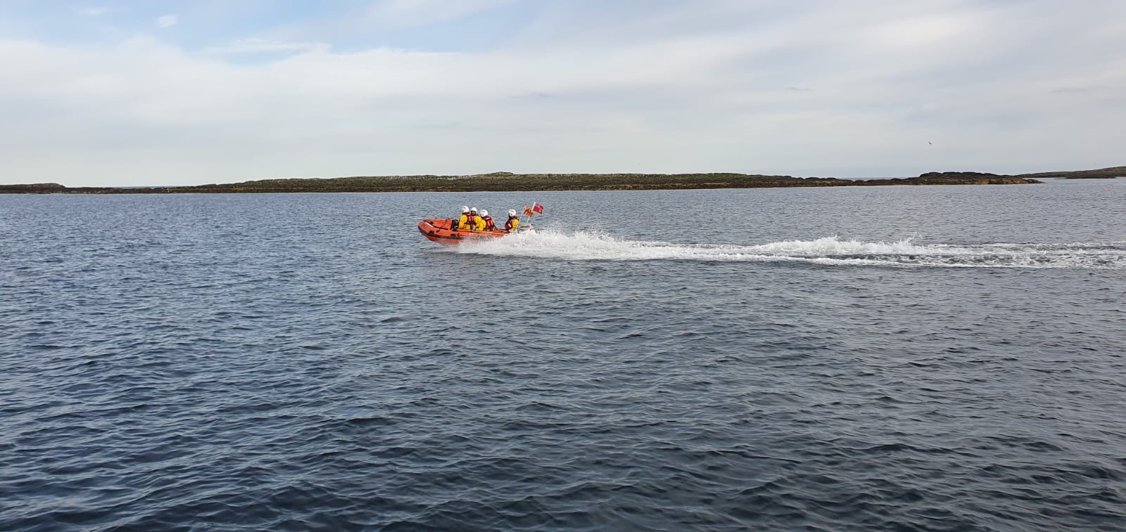 Seahouses RNLI launch to paddle boarders caught in rip current crew of four on open water in inshore lifeboat
