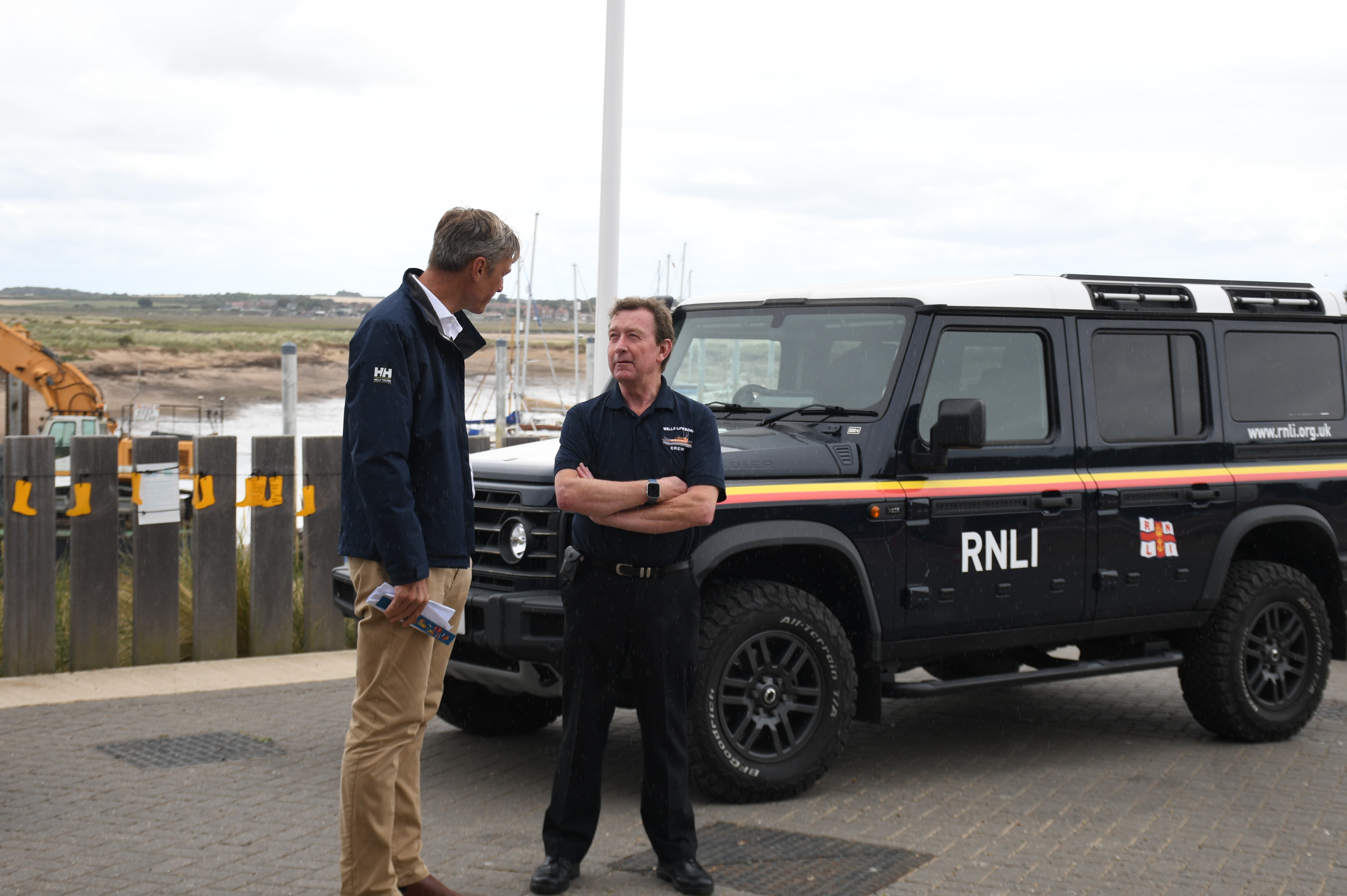 RNLI Chief Executive Peter Sparkes at Wells RNLI with Lifeboats Operations Manager Chris Hardy in front of RNLI branded Landrover
