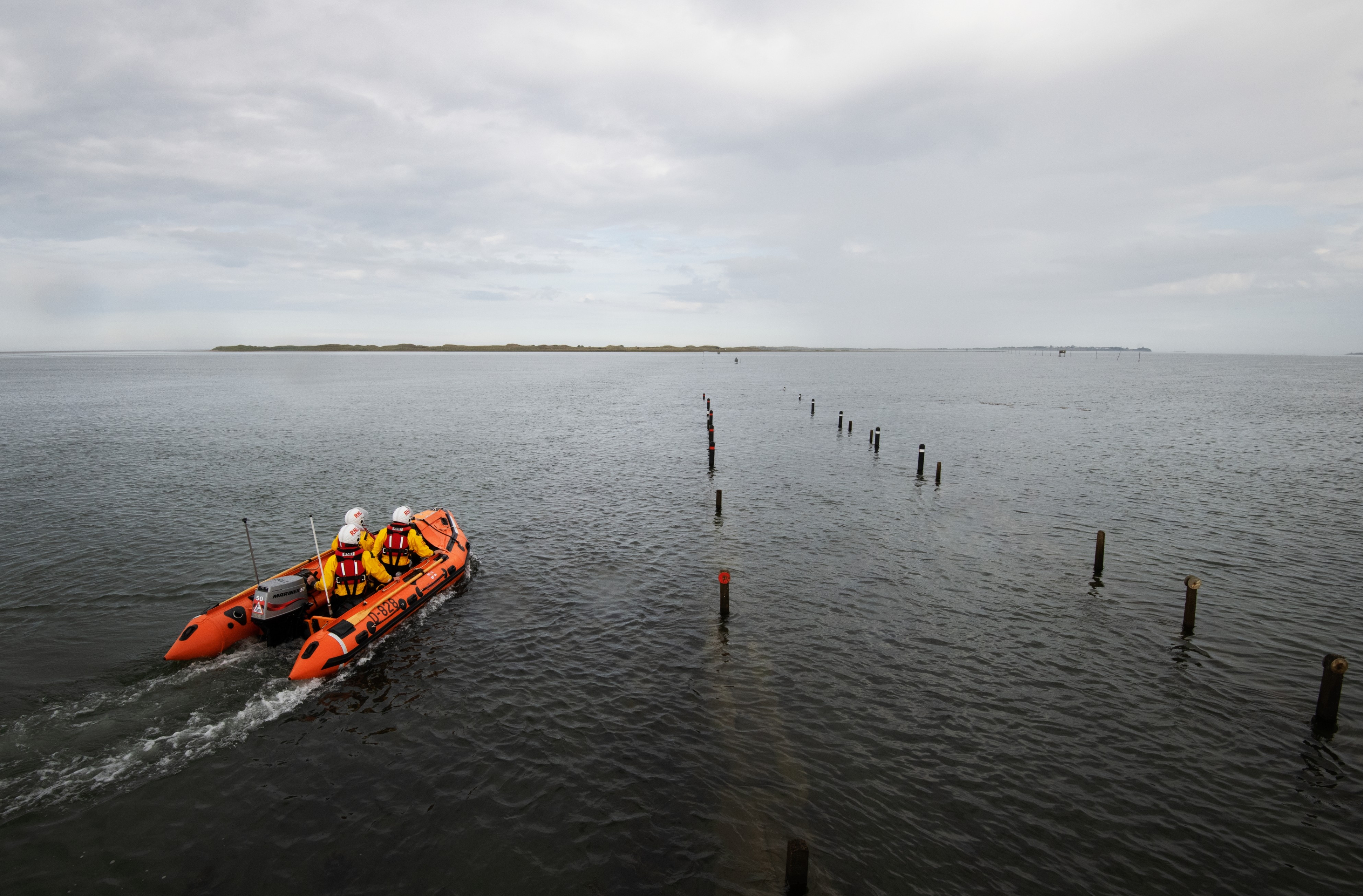 Seahouses RNLI D class lifeboat on open water Holy Island causeway