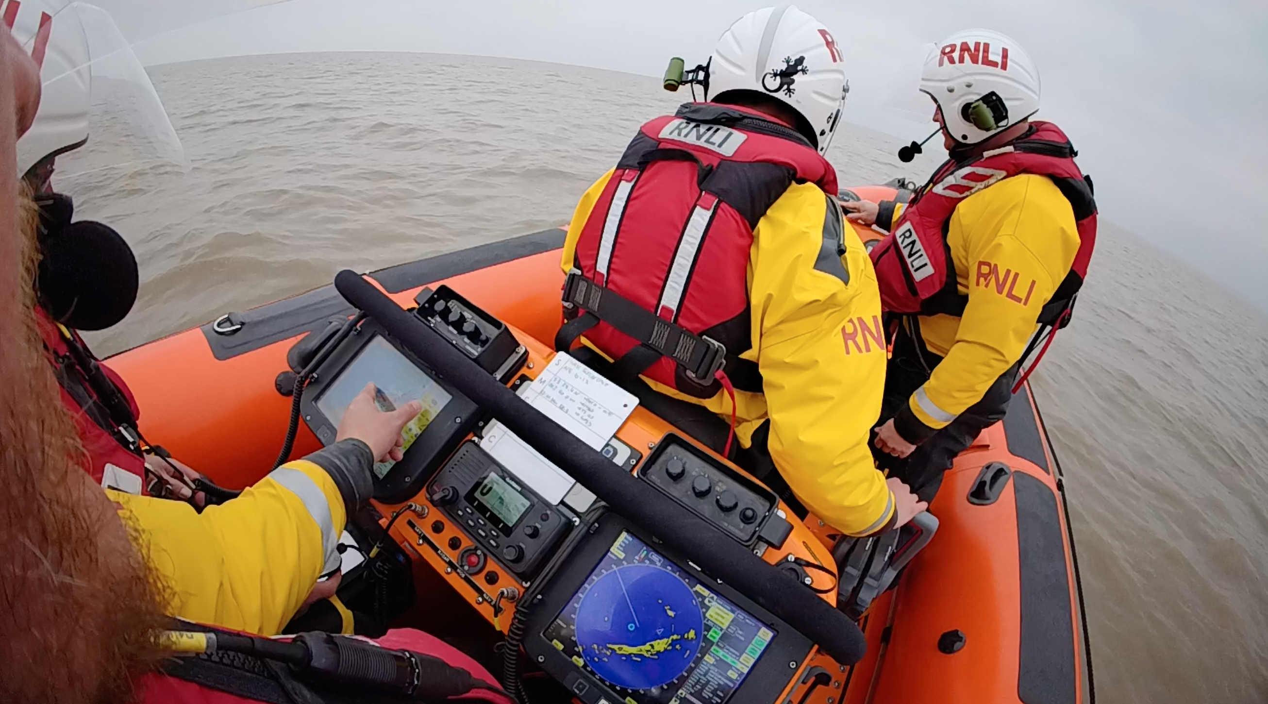 Mike (right) showing Harry (on the Helm seat) the controls of the Atlantic 85 lifeboat, My Lady Anne.