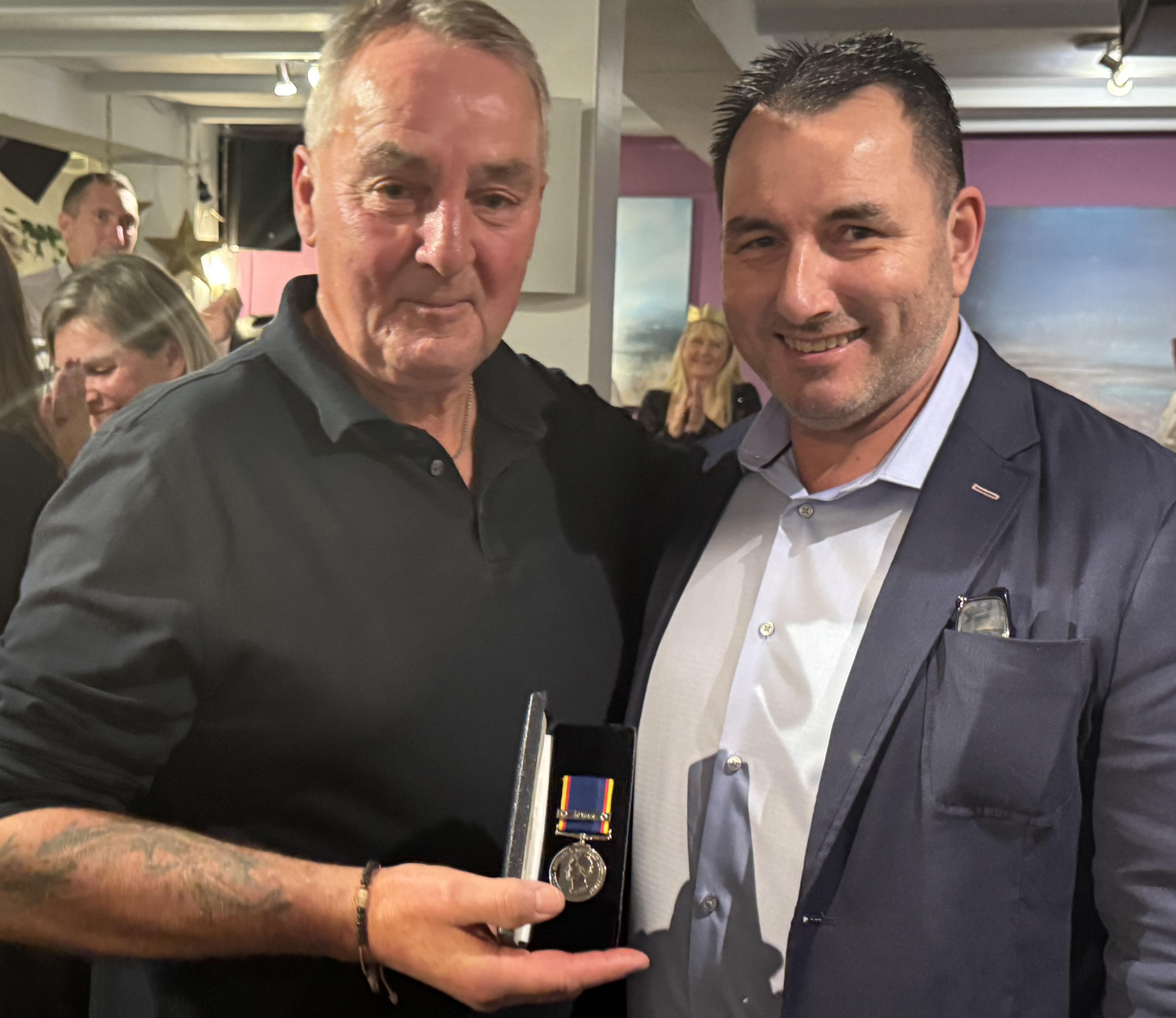 Two men with medal